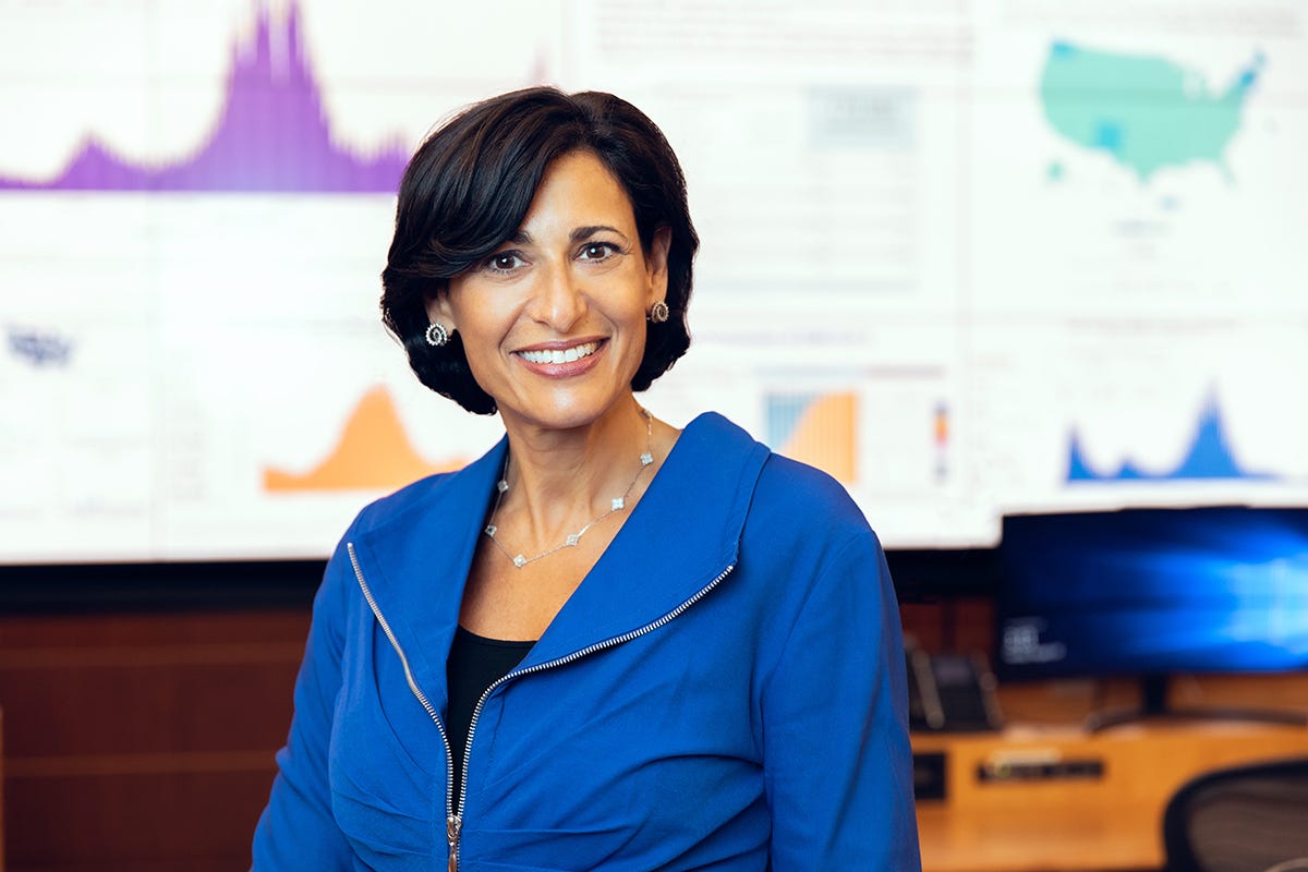 smiling dr walensky standing in CDC mission control for covid response