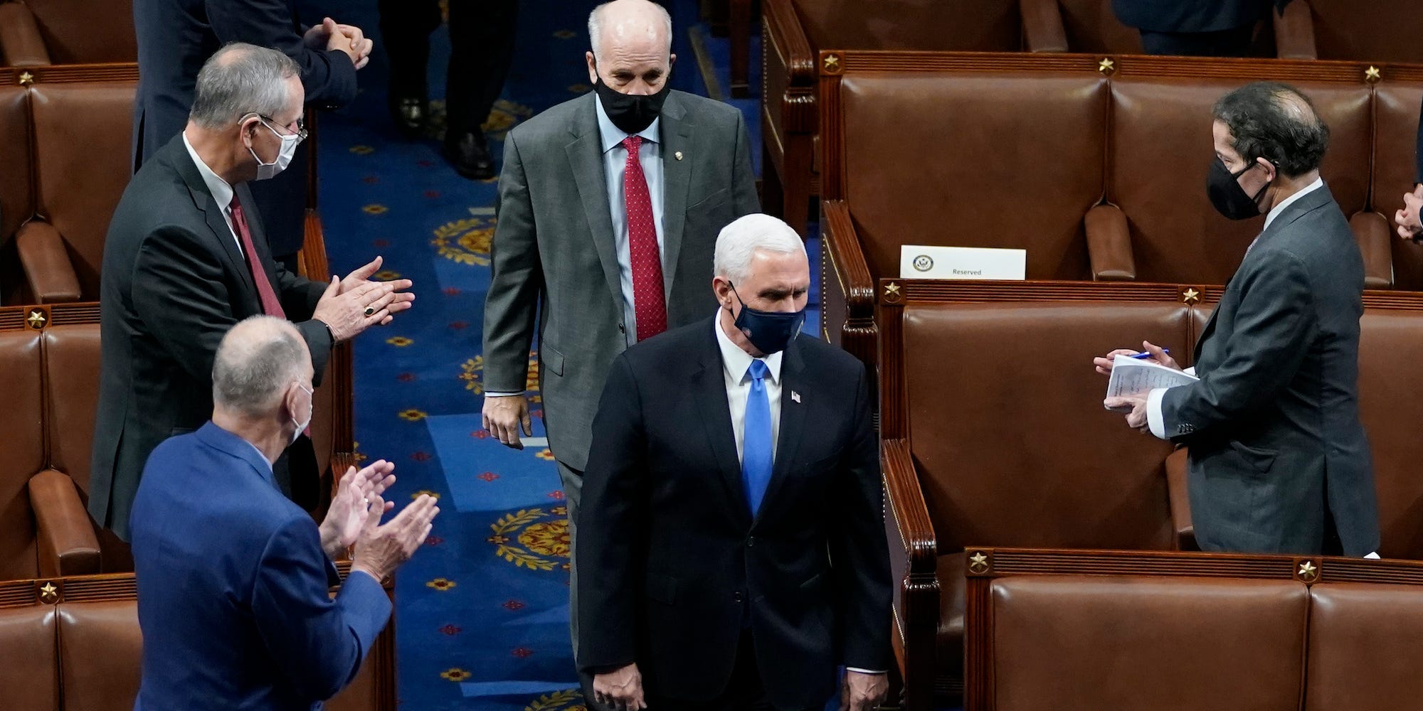 : U.S. Vice President Mike Pence walks into the House Chamber during a reconvening of a joint session of Congress on January 06, 2021 in Washington, DC. Members of Congress returned to the House Chamber after being evacuated when protesters stormed the Capitol and disrupted a joint session to ratify President-elect Joe Biden's 306-232 Electoral College win over President Donald Trump.