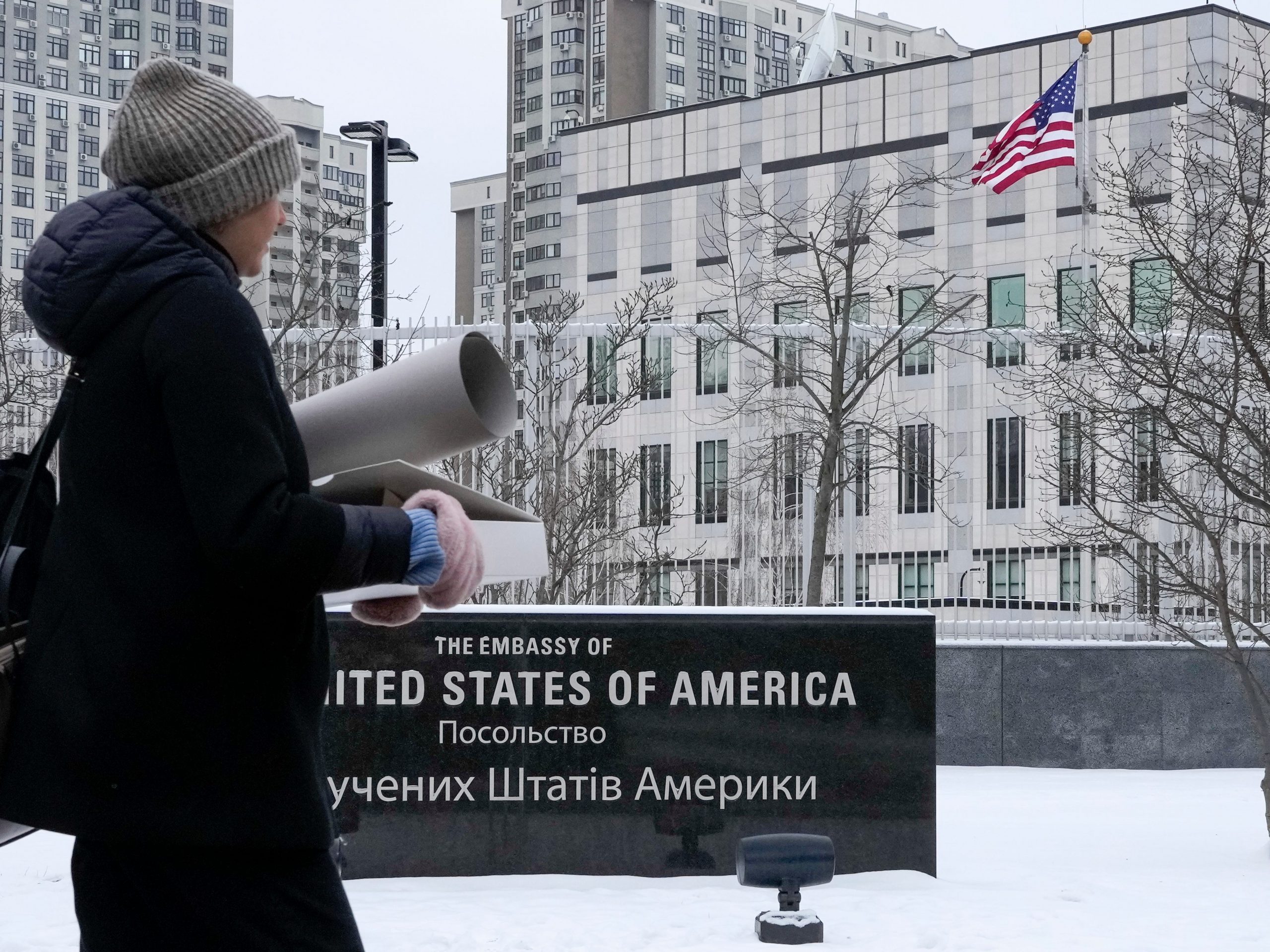 A woman walks past the U.S. Embassy in Kyiv, Ukraine, Monday, Jan. 24, 2022