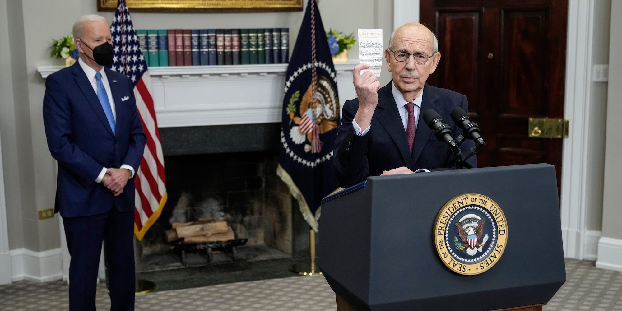 U.S. President Joe Biden looks on as U.S. Supreme Court Associate Justice Stephen Breyer holds up a pocket Constitution and speaks about his coming retirement in the Roosevelt Room of the White House on January 27, 2022 in