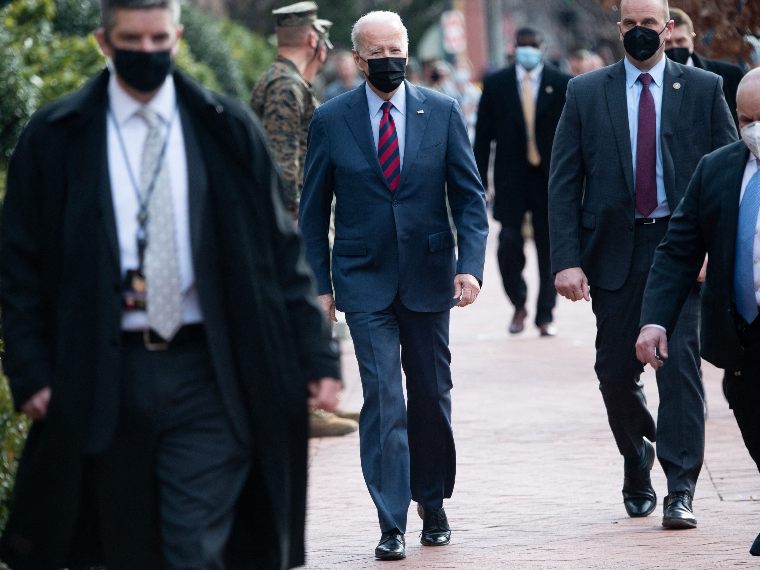 President Joe Biden surrounded by US Secret Service members