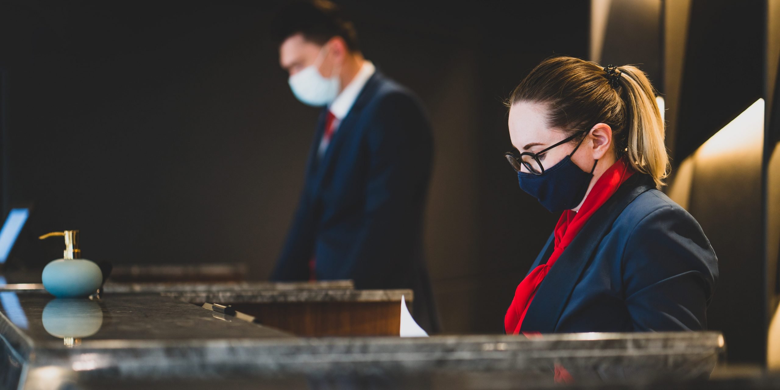 Hotel reception wearing covid-19 facemask