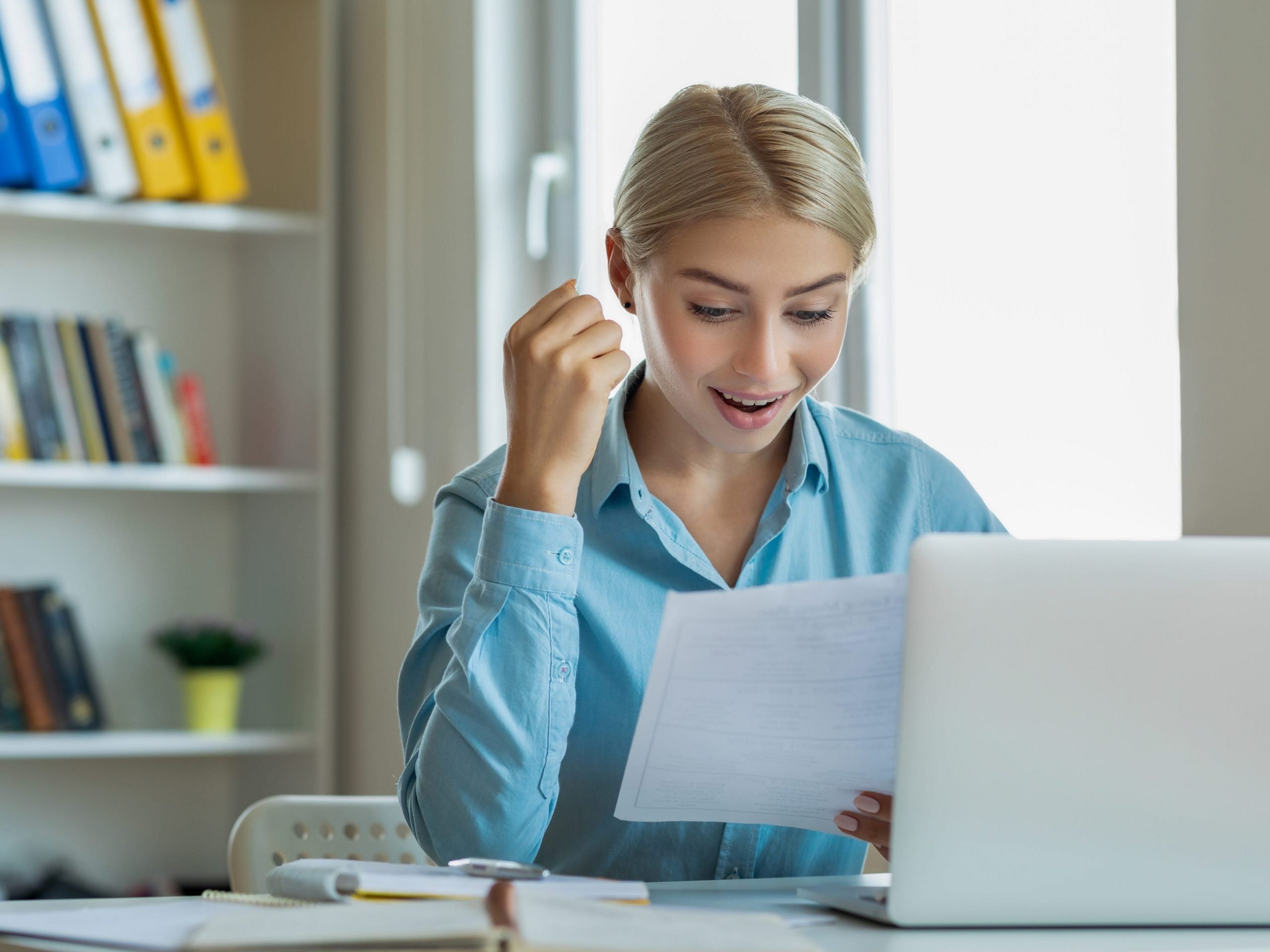 Woman reading a letter with excitement