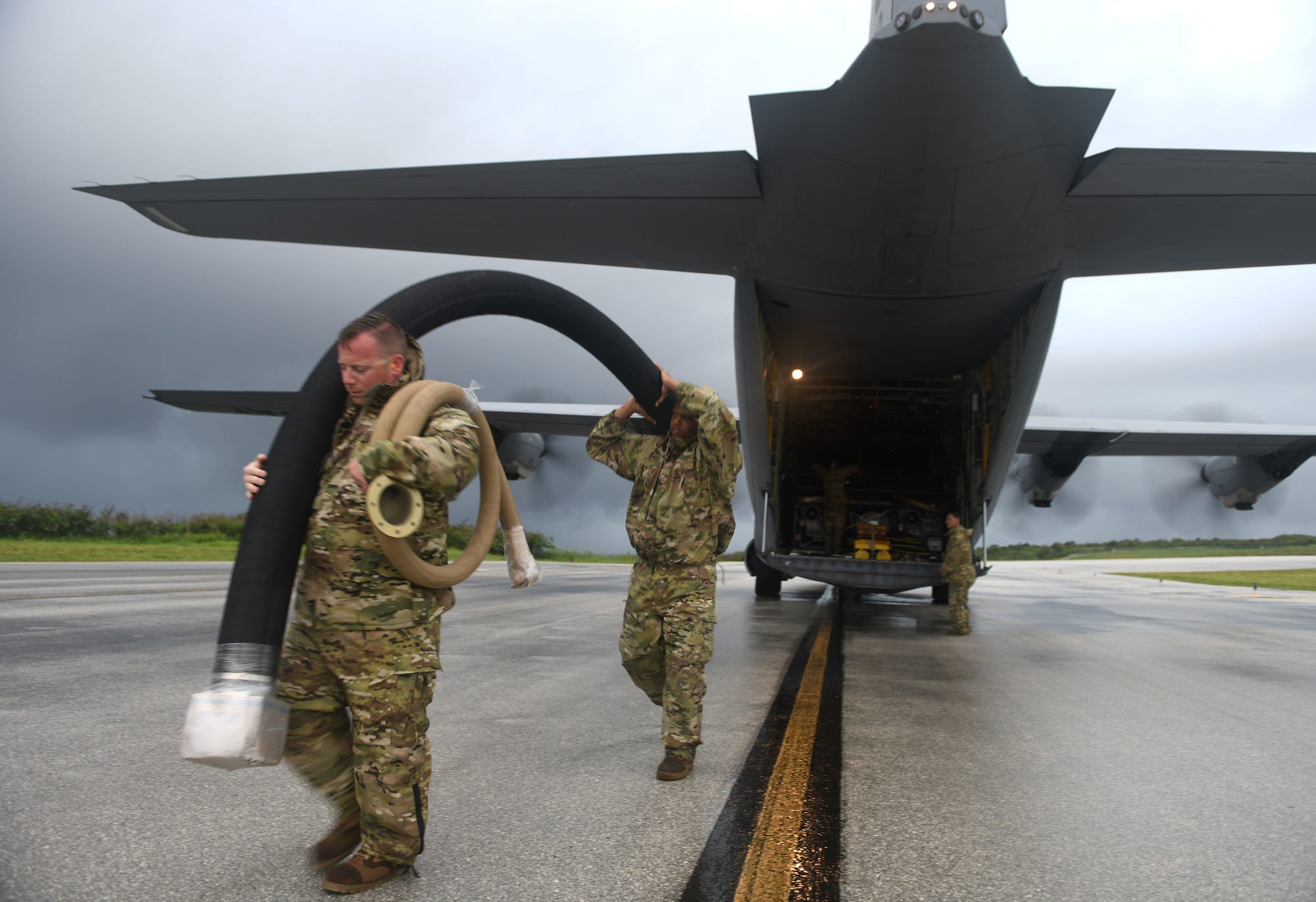 Air Force airmen and C-130J at Tinian