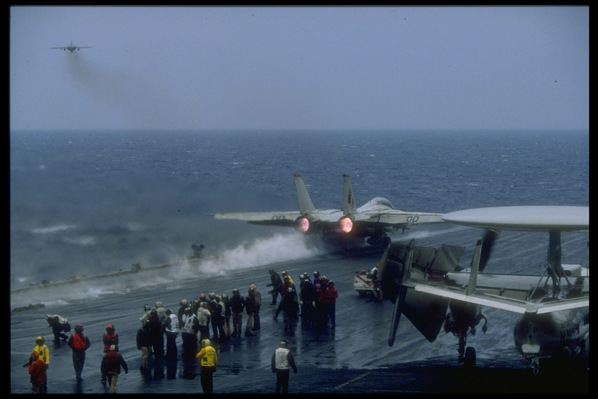 Navy F-14 Tomcat takes off of aircraft carrier USS Forrestal
