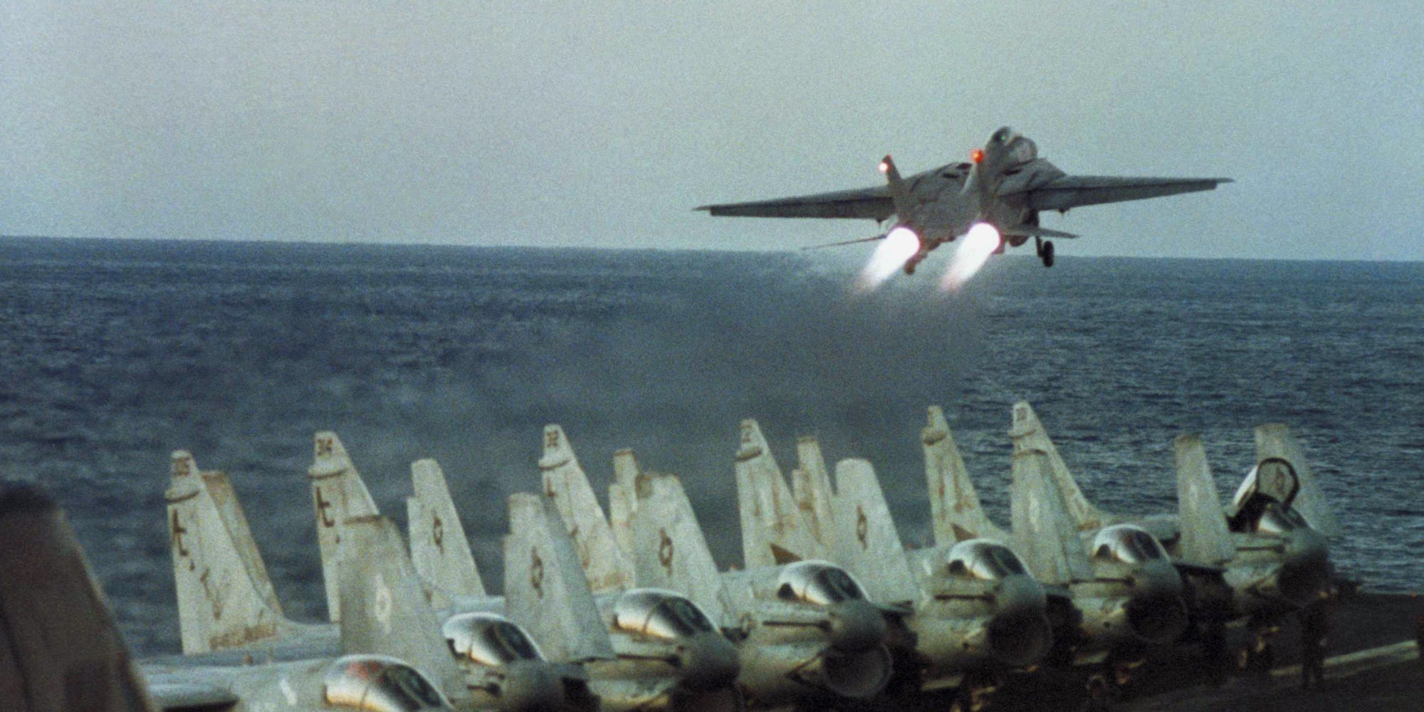 Navy F-14 takes off of of aircraft carrier USS John F. Kennedy