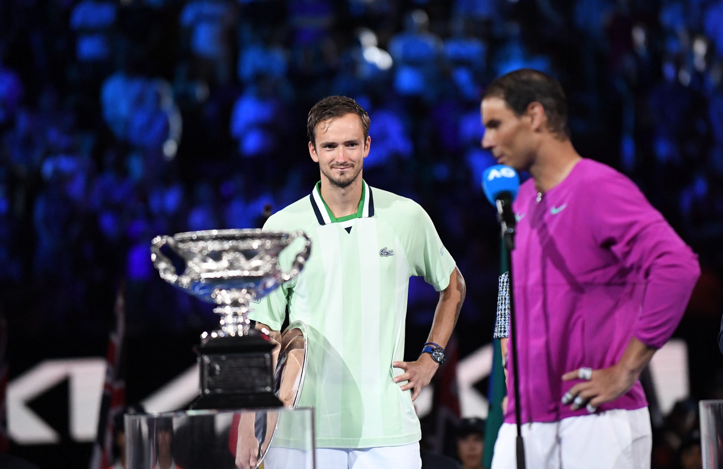 Daniil Medvedev (left) looks on as Rafael Nadal accepts his Australian Open trophy.