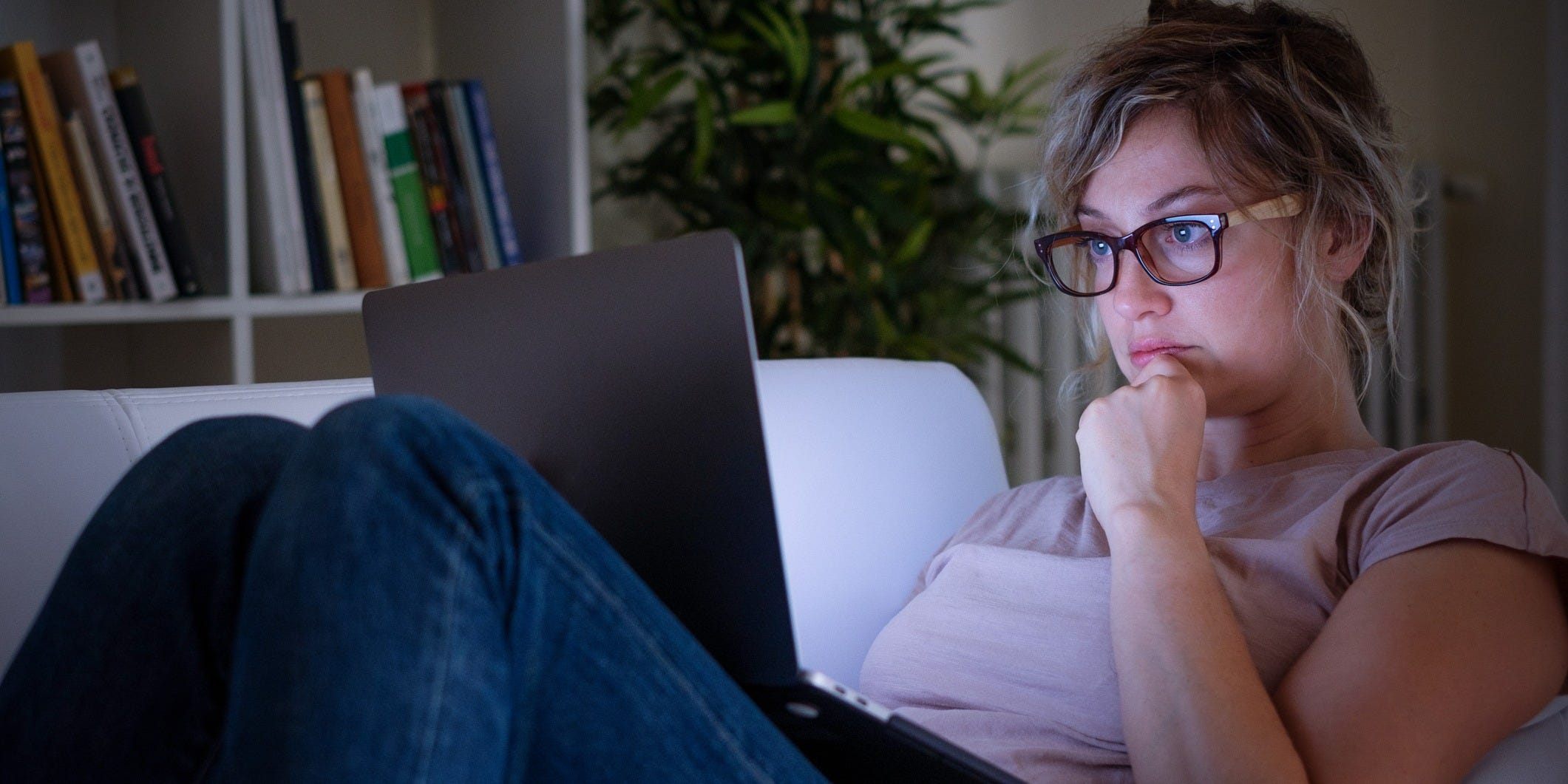 woman using laptop on the couch