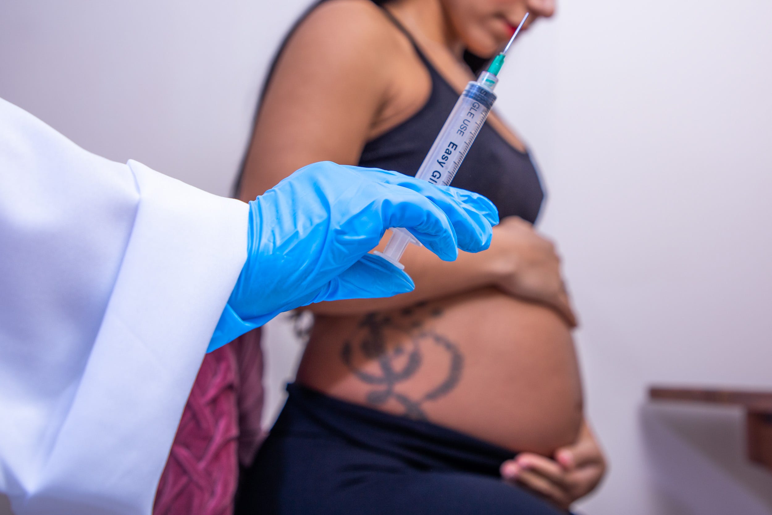 A pregnant mother getting an injection.