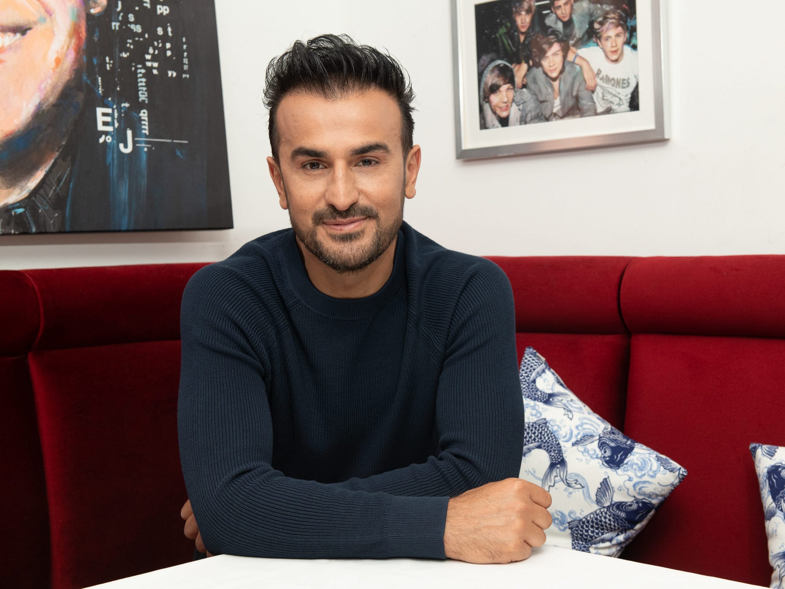 Zach Erdem seated at his Southampton restaurant Blu Mar.