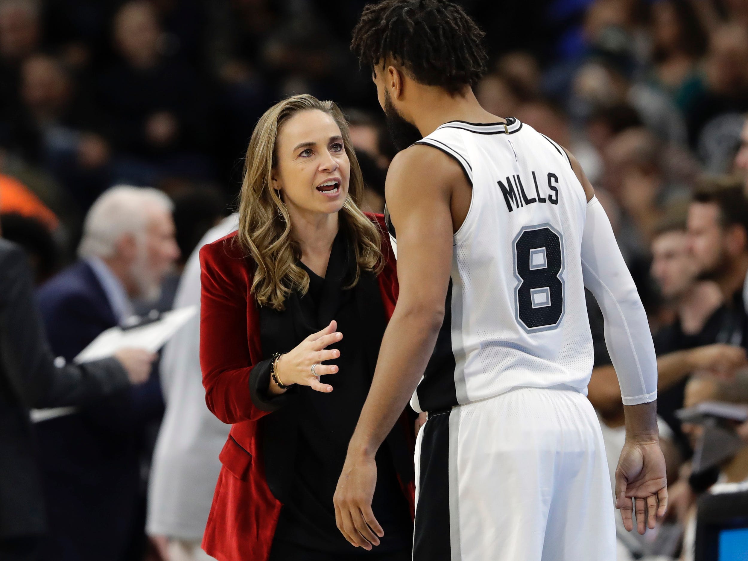San Antonio Spurs assistant coach Becky Hammon speaks with Patty Mills.