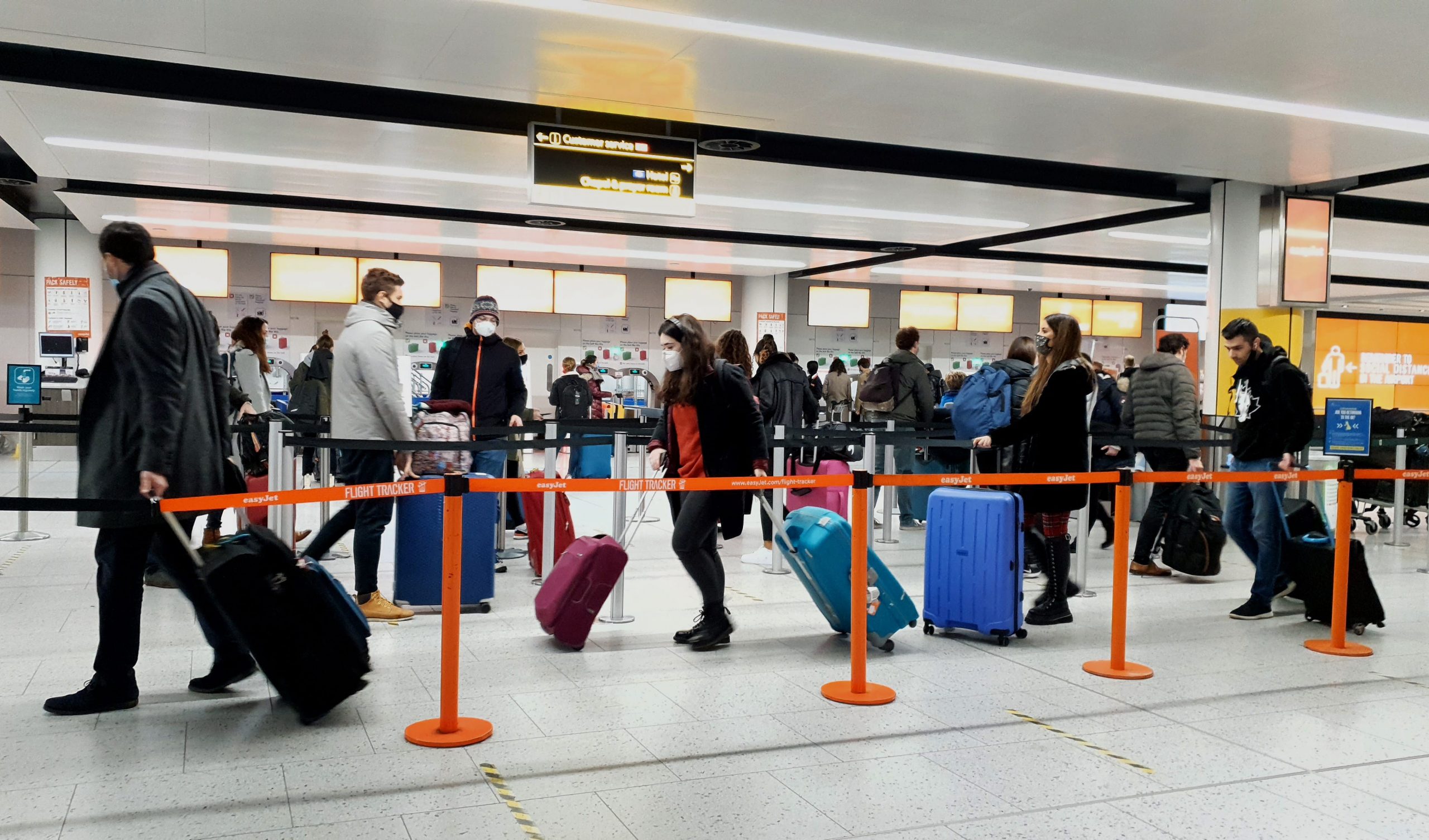 Passengers queuing up to check their suitcases in before departure in Gatwick Airport