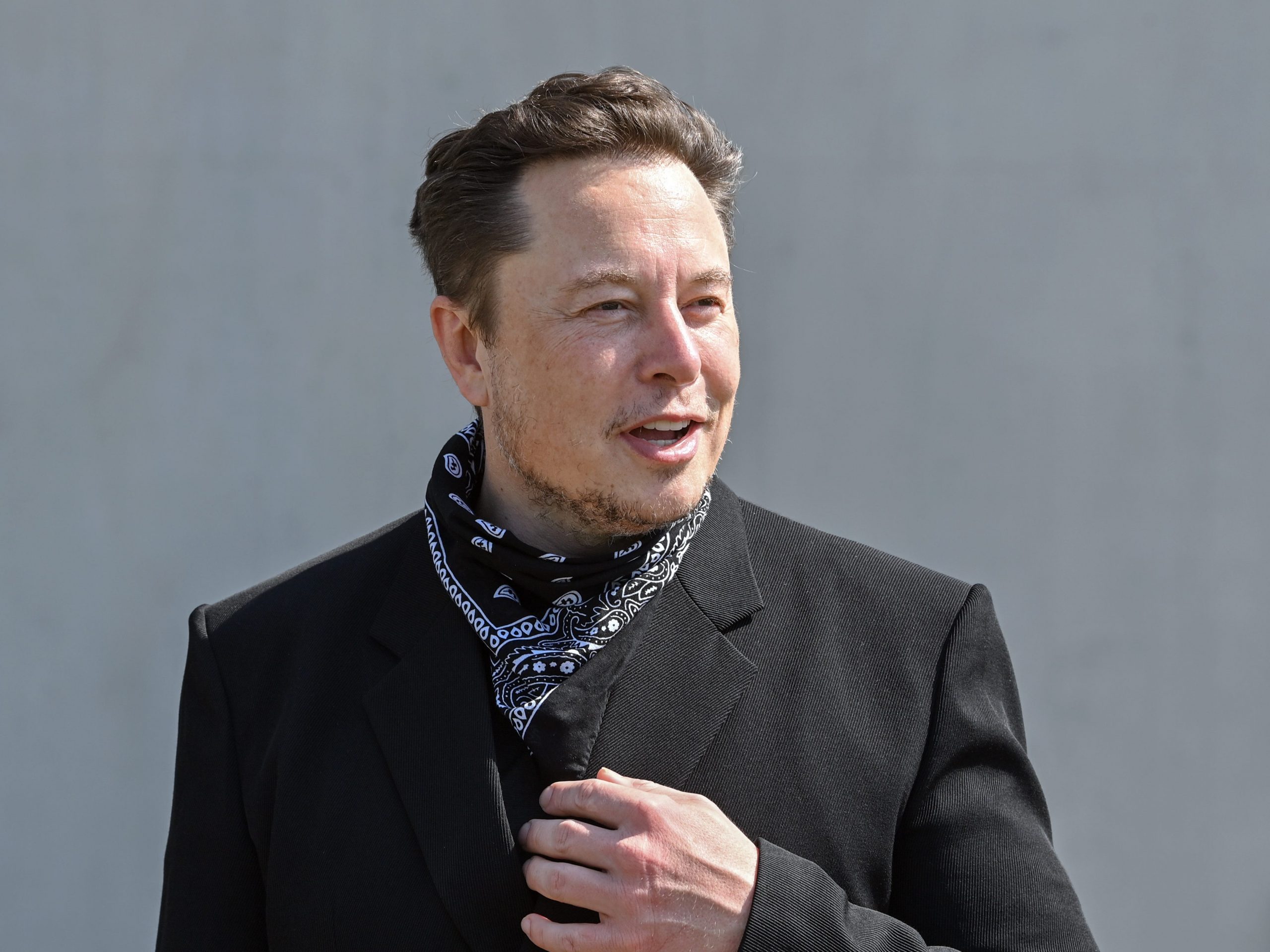 Elon Musk, Tesla CEO, stands at a press event on the grounds of the Tesla Gigafactory.
