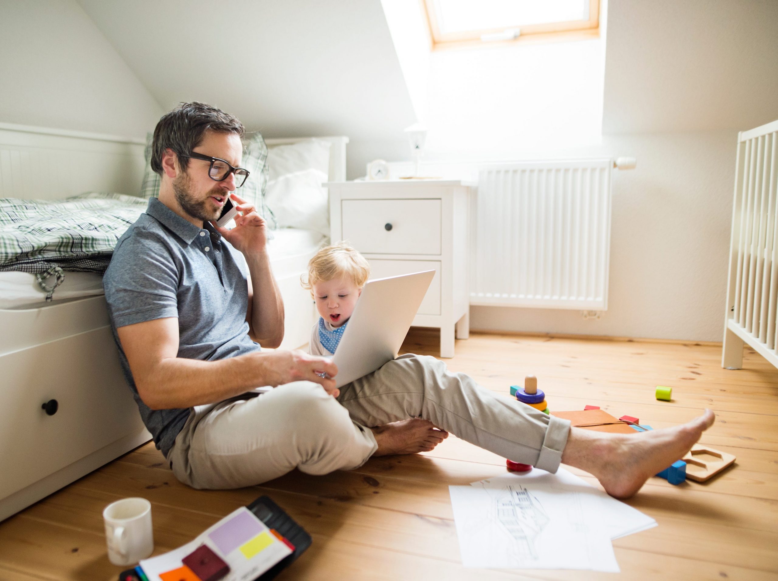 A father with his little son working from home
