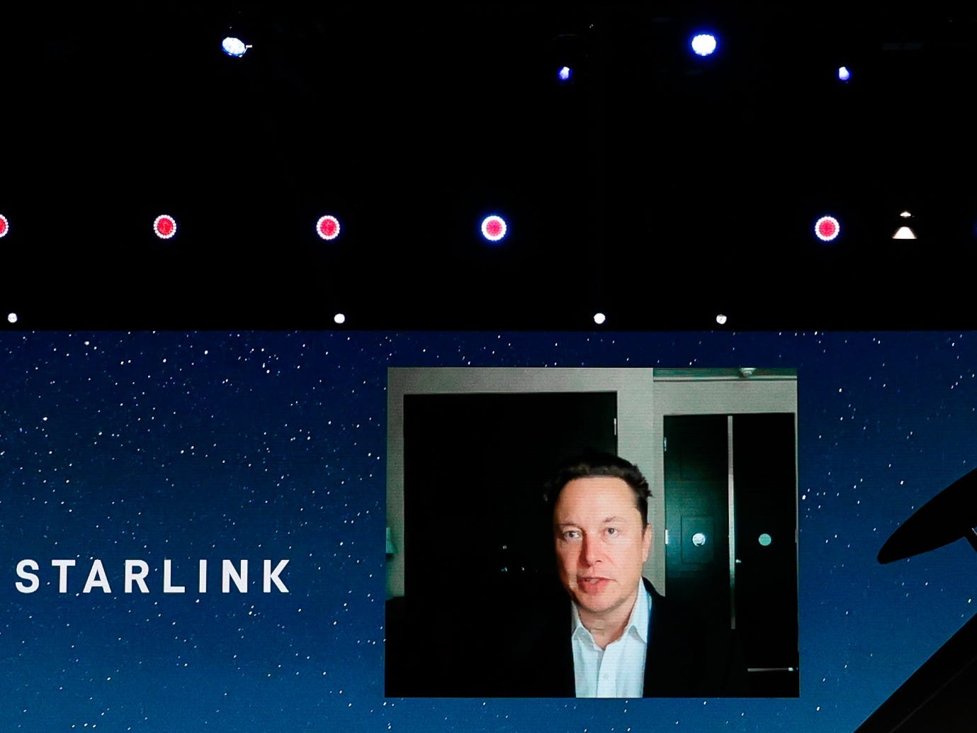 SpaceX founder Elon Musk on a video stage speaking about Starlink