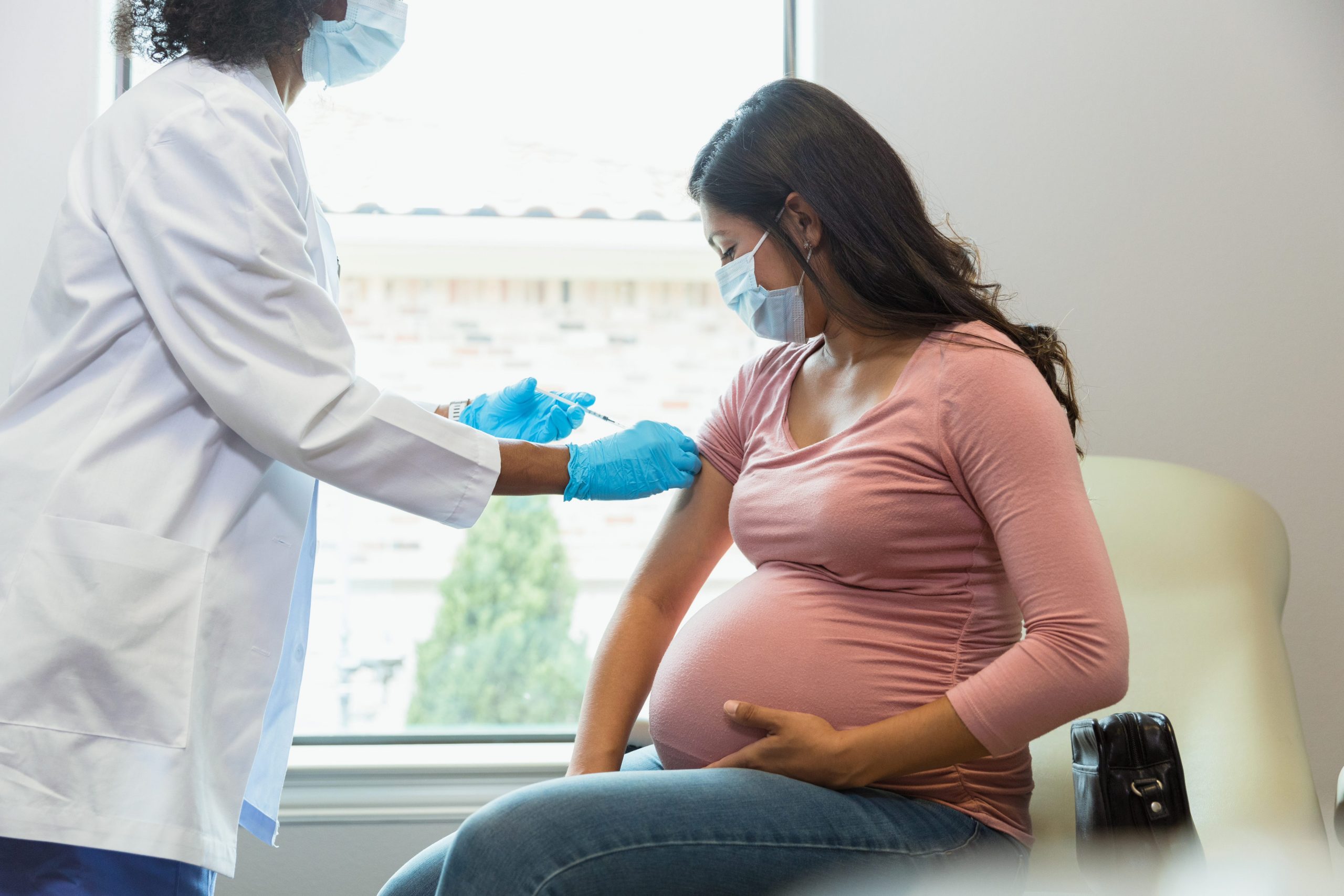 A pregnant woman getting a vaccine