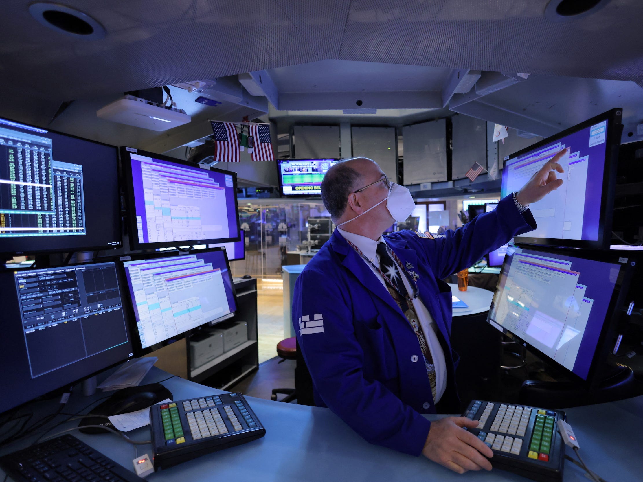 Trader points at screen at NYSE