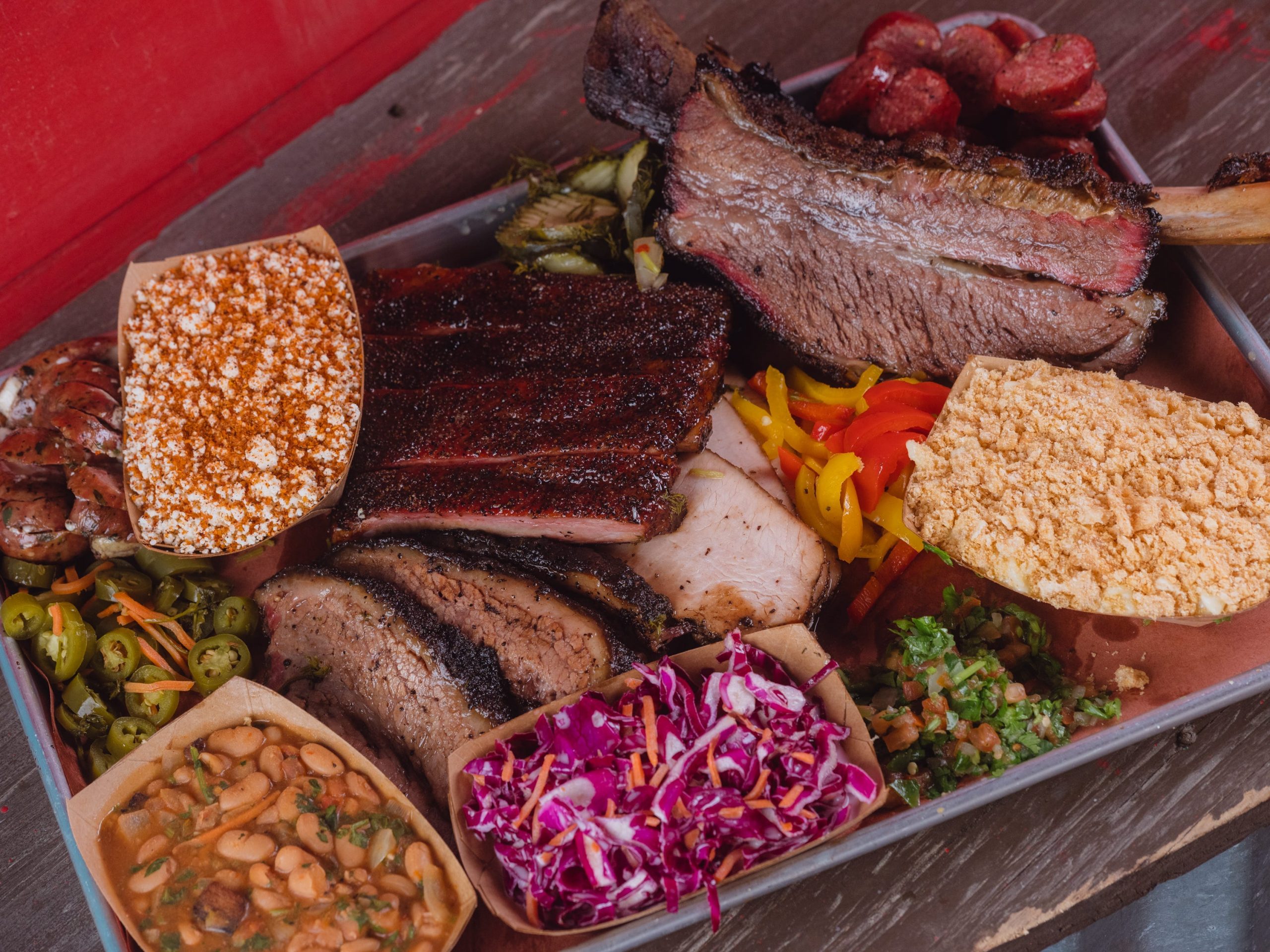 A tray of barbecued meat and sides.