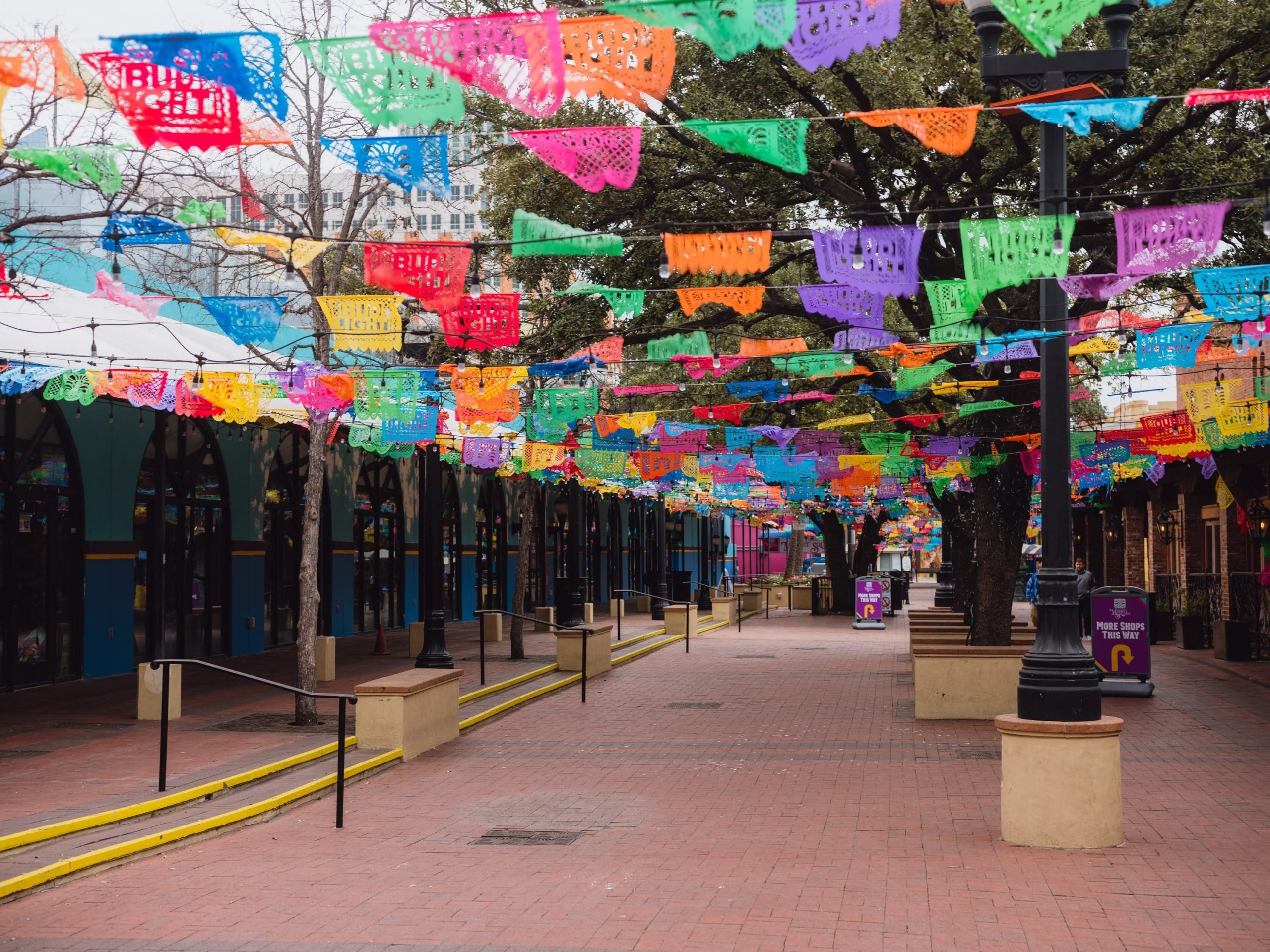 Colorful banners strewn above a plaza.