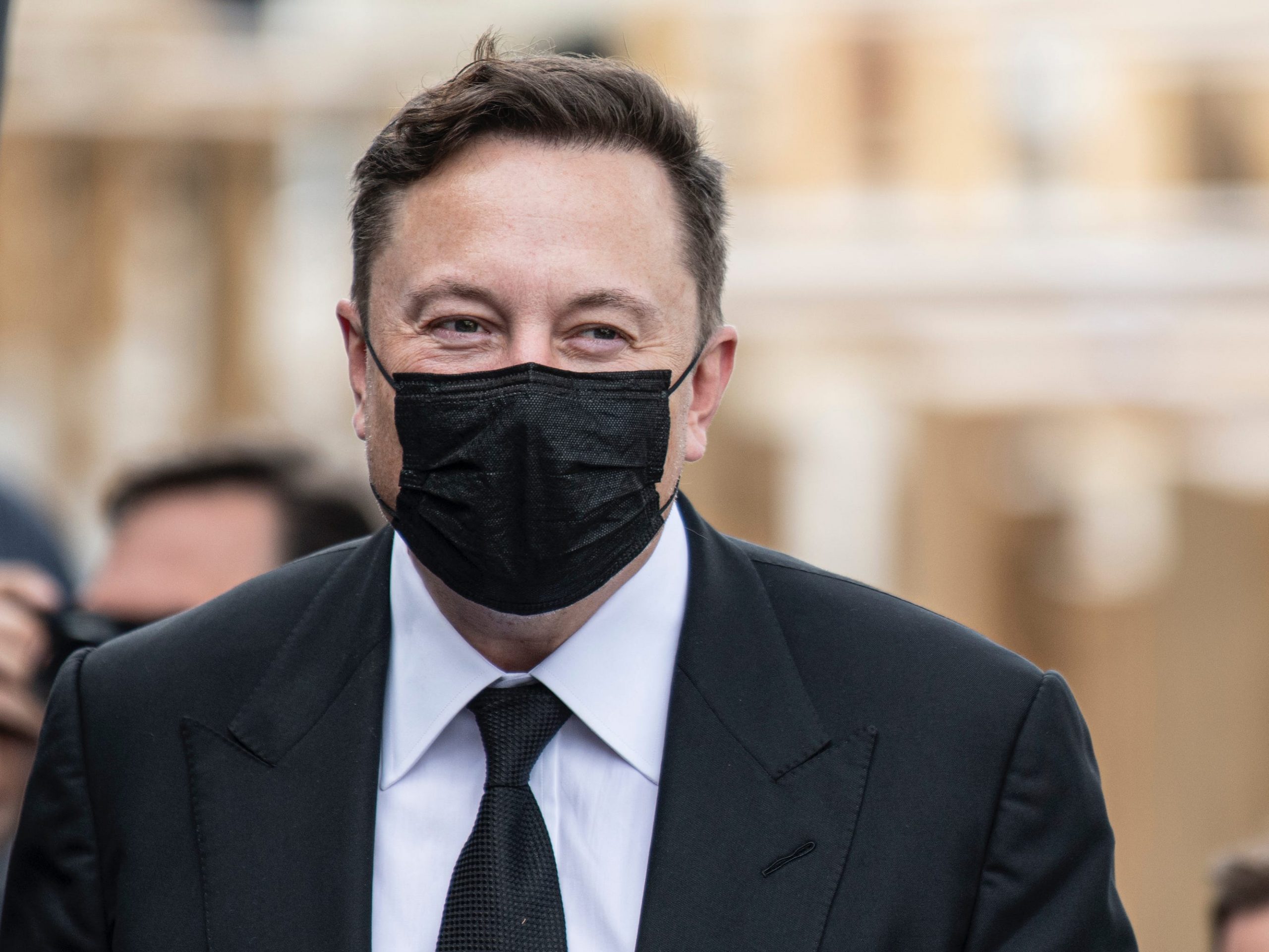 Elon Musk wears a mask.