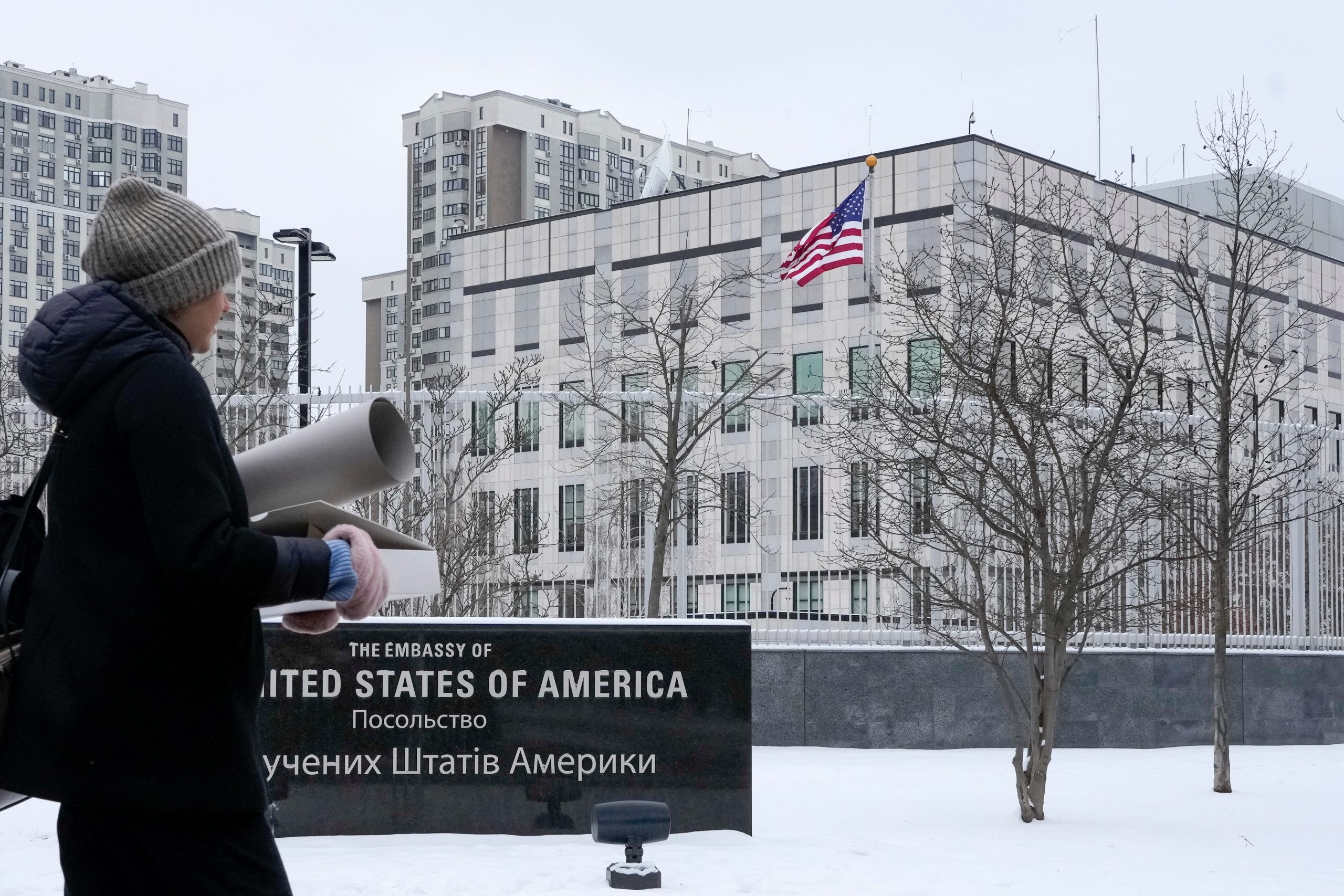 A woman walks past the U.S. Embassy in Kyiv, Ukraine, Monday, Jan. 24, 2022