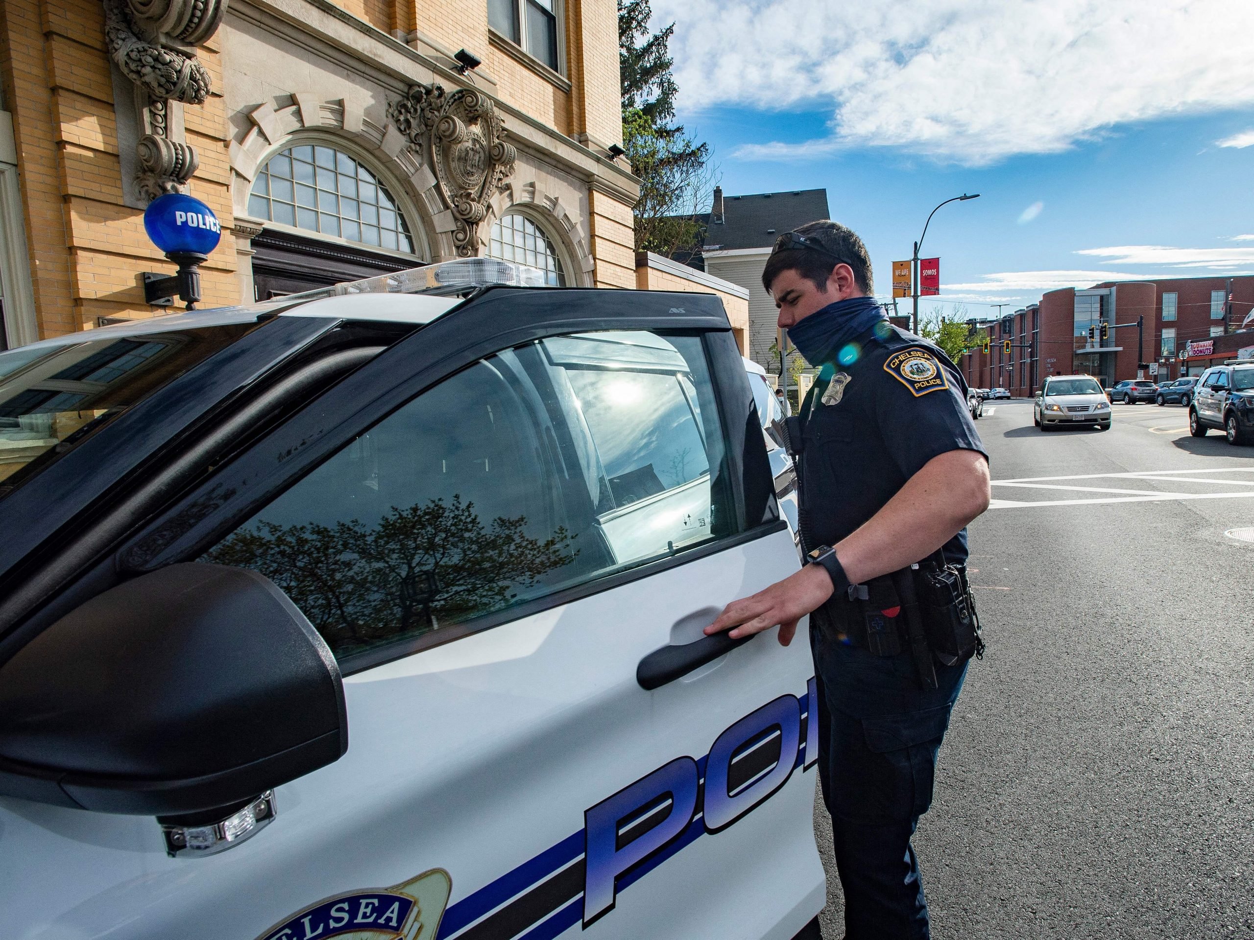 Officer Daniel Arteaga, an officer with two years on the force, leaves the Police Station and enters his cruiser for the second part of his double shift in Chelsea, Massachusetts on May 1, 2021.