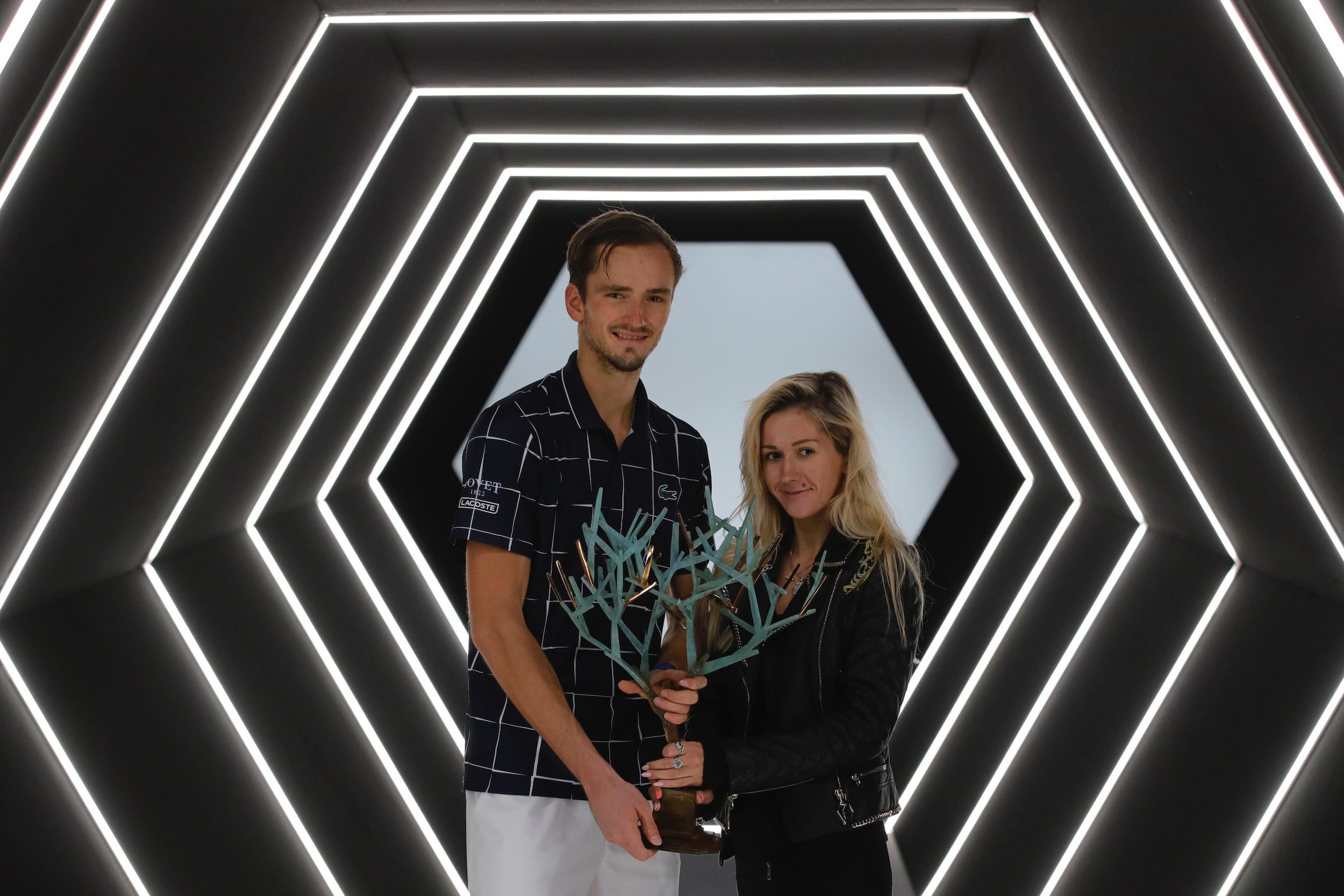 Daniil and Daria Medvedev pose with his trophy after the 2020 Paris Masters tennis tournament final.