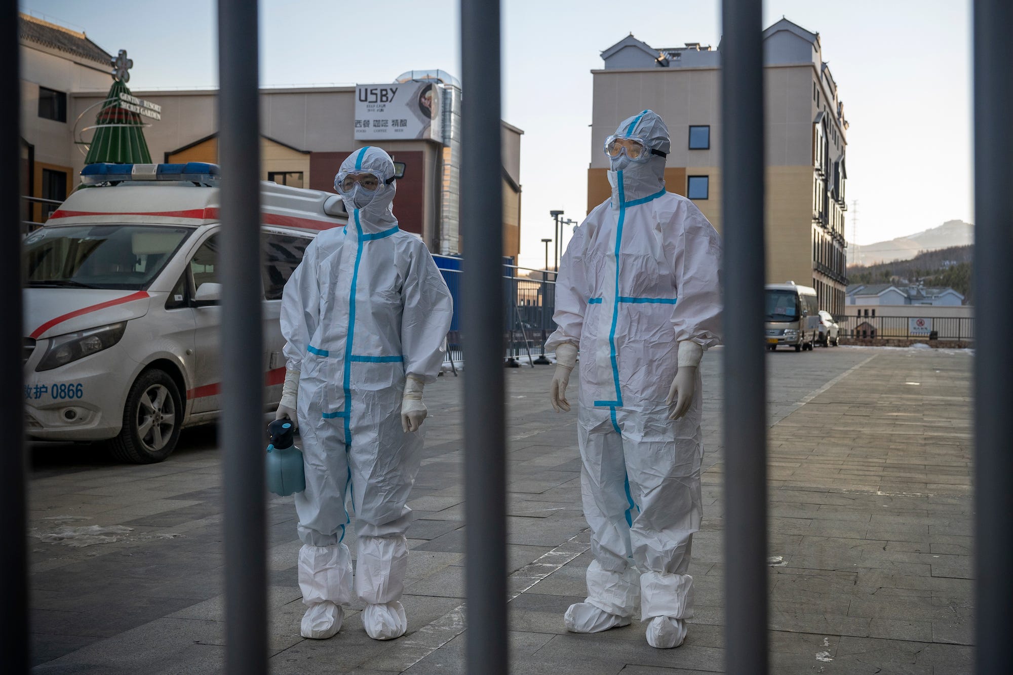 Medical workers wearing PPE stand behind a closed gate inside an area restricted to the general people at Prince Ski Town on December 05, 2021 in Taizicheng, Zhangjiakou, China as winter sports events are held in preparation of the upcoming Beijing 2022 Winter Olympics. The games will be held inside a bubble to prevent the spread of Covid-19 to the rest of the country