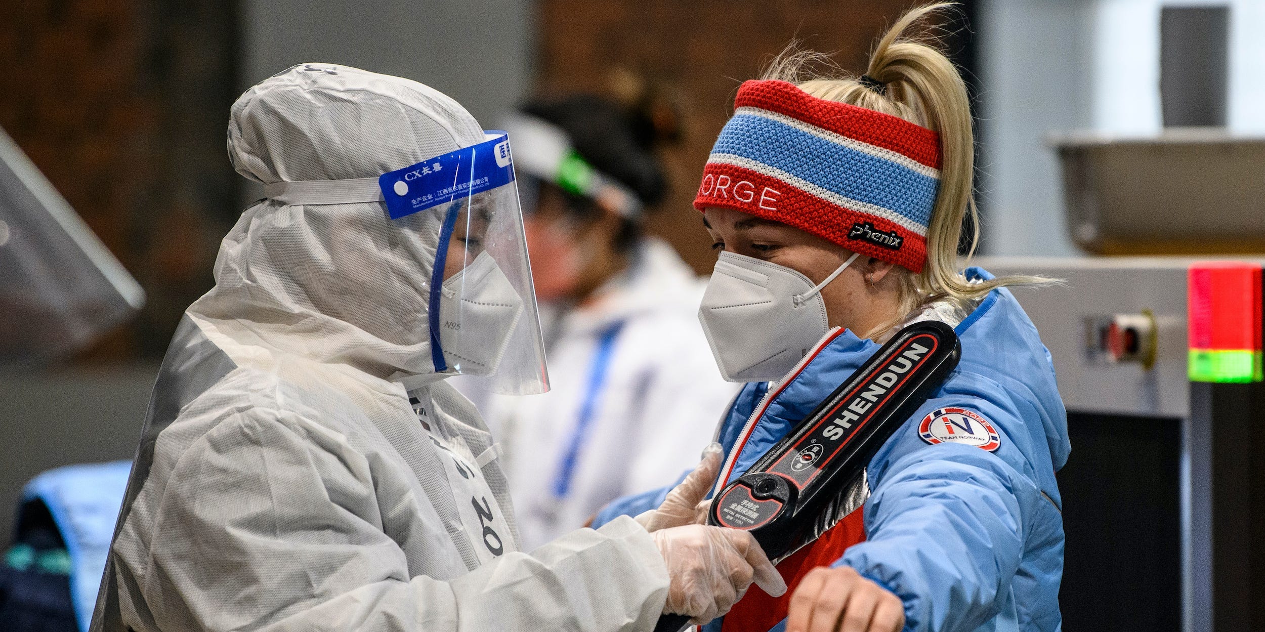 A Norwegian Olympic team member goes through security checks at the Olympic village ahead of the 2022 Winter Games.