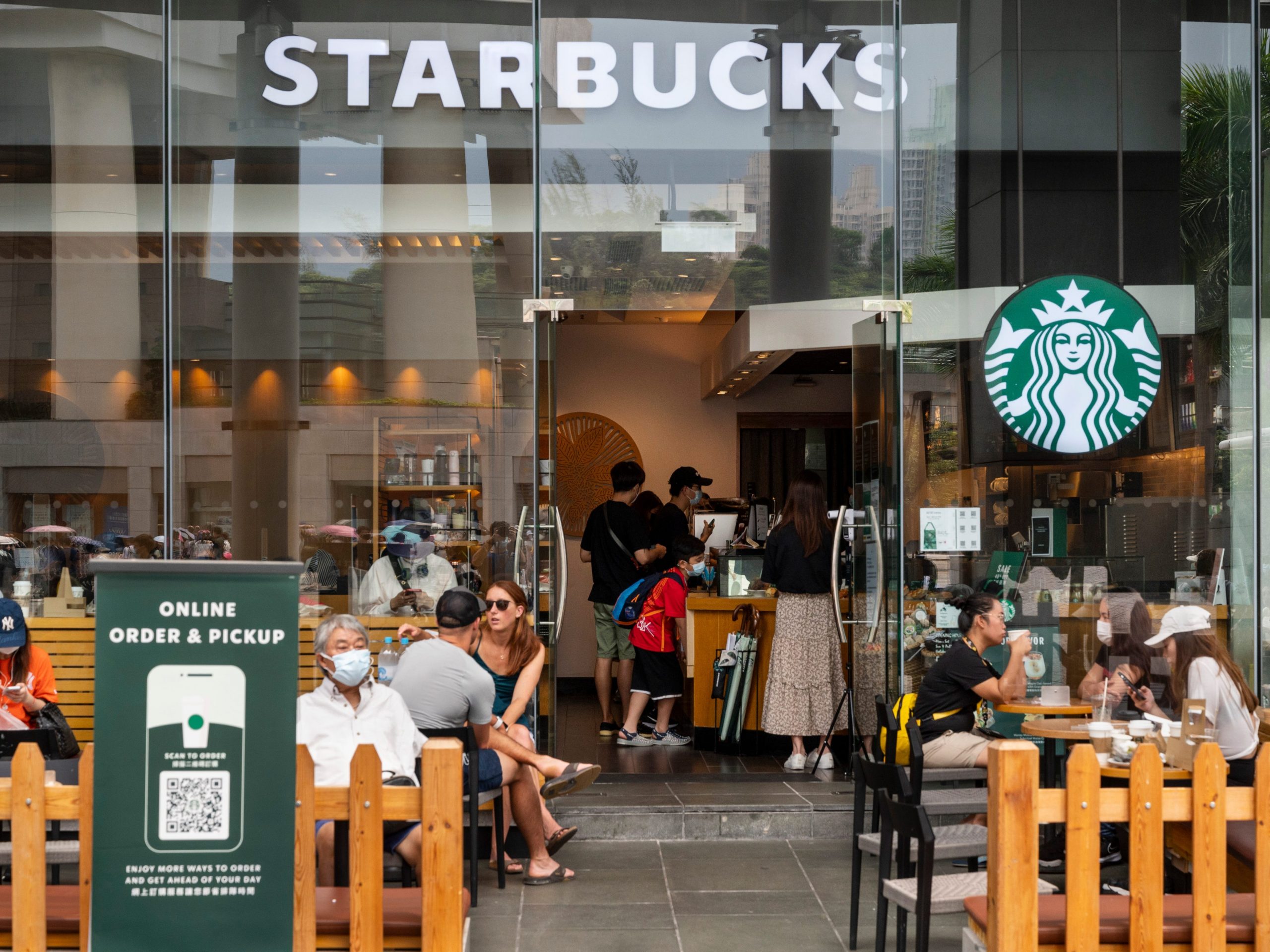 Customers are seen at the American multinational chain Starbucks Coffee store seen in Hong Kong's Tung Chung district.