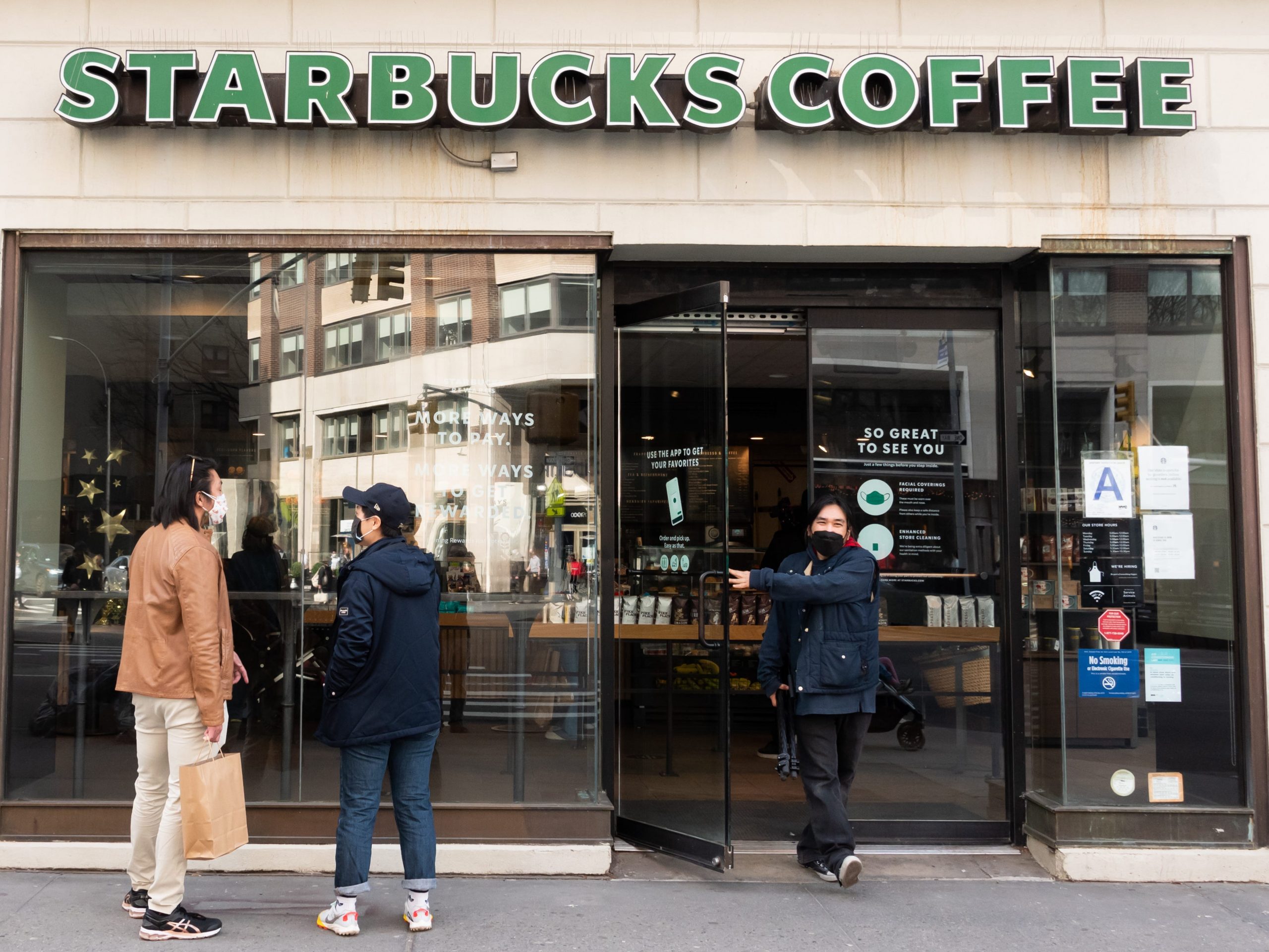 People stand outside Starbucks on the Upper West Side amid the coronavirus pandemic on March 23, 2021 in New York City.