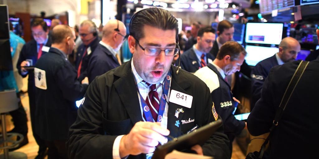 Traders work during the opening bell at the New York Stock Exchange (NYSE)