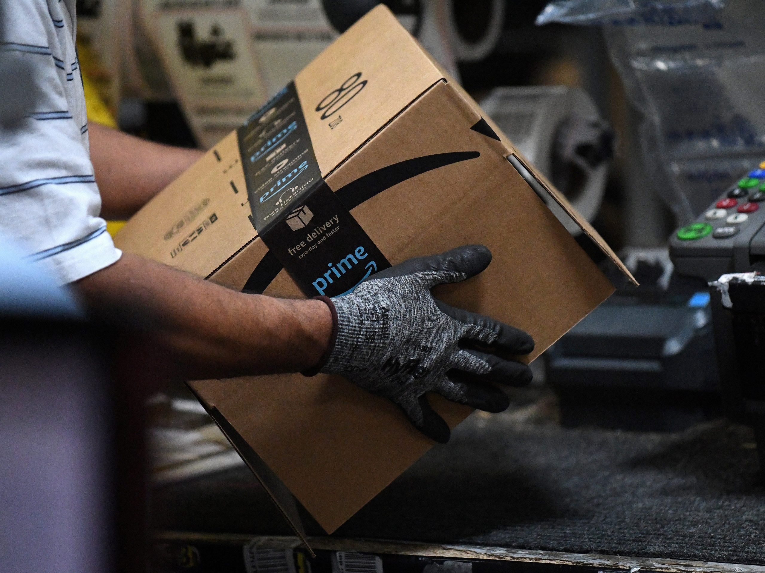 FILE PHOTO: A worker assembles a box for delivery at the Amazon fulfillment center in Baltimore, Maryland, U.S., April 30, 2019. REUTERS/Clodagh Kilcoyne/File Photo