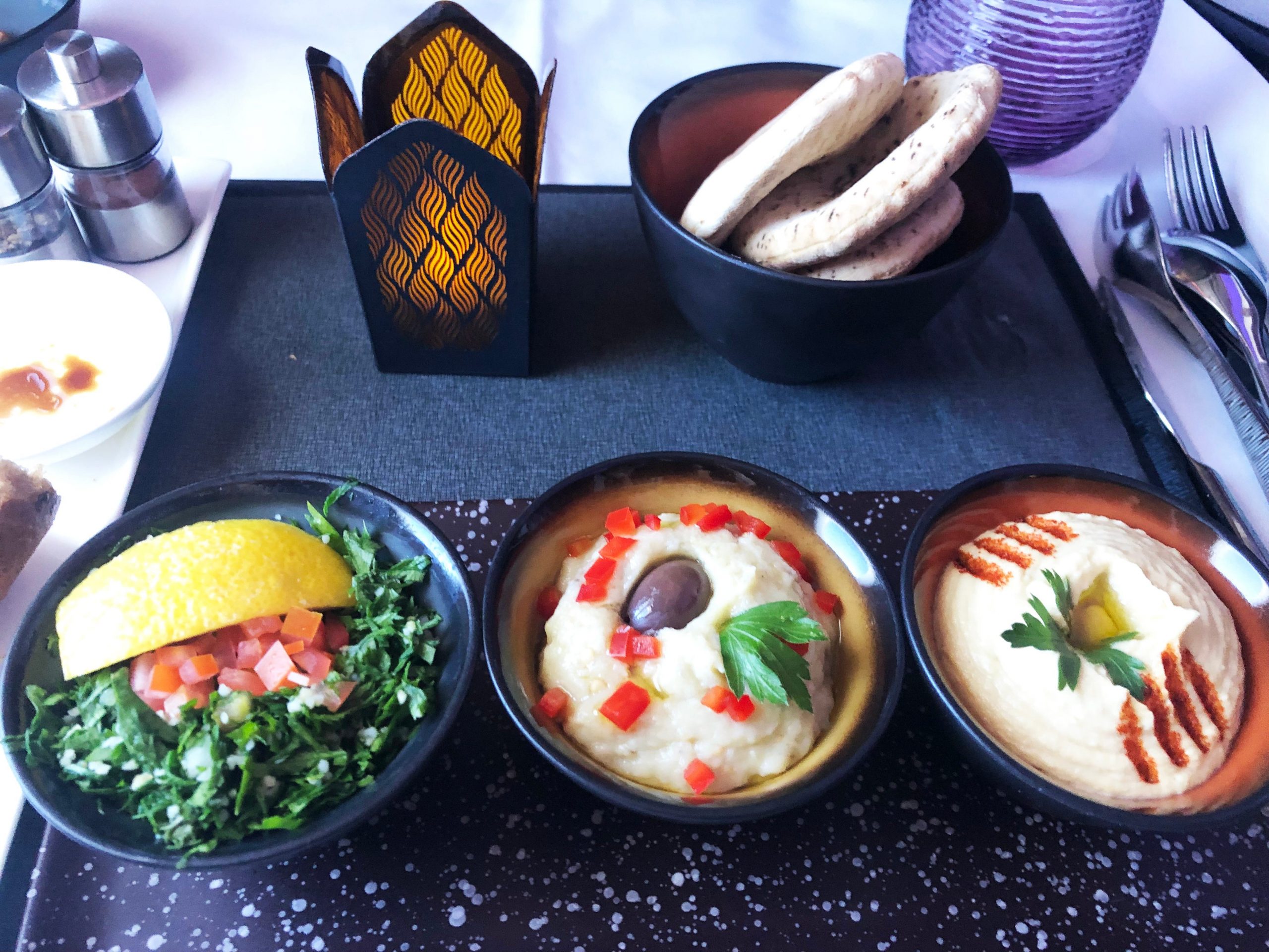 Mezze with hummus, moutabel, and tabouleh