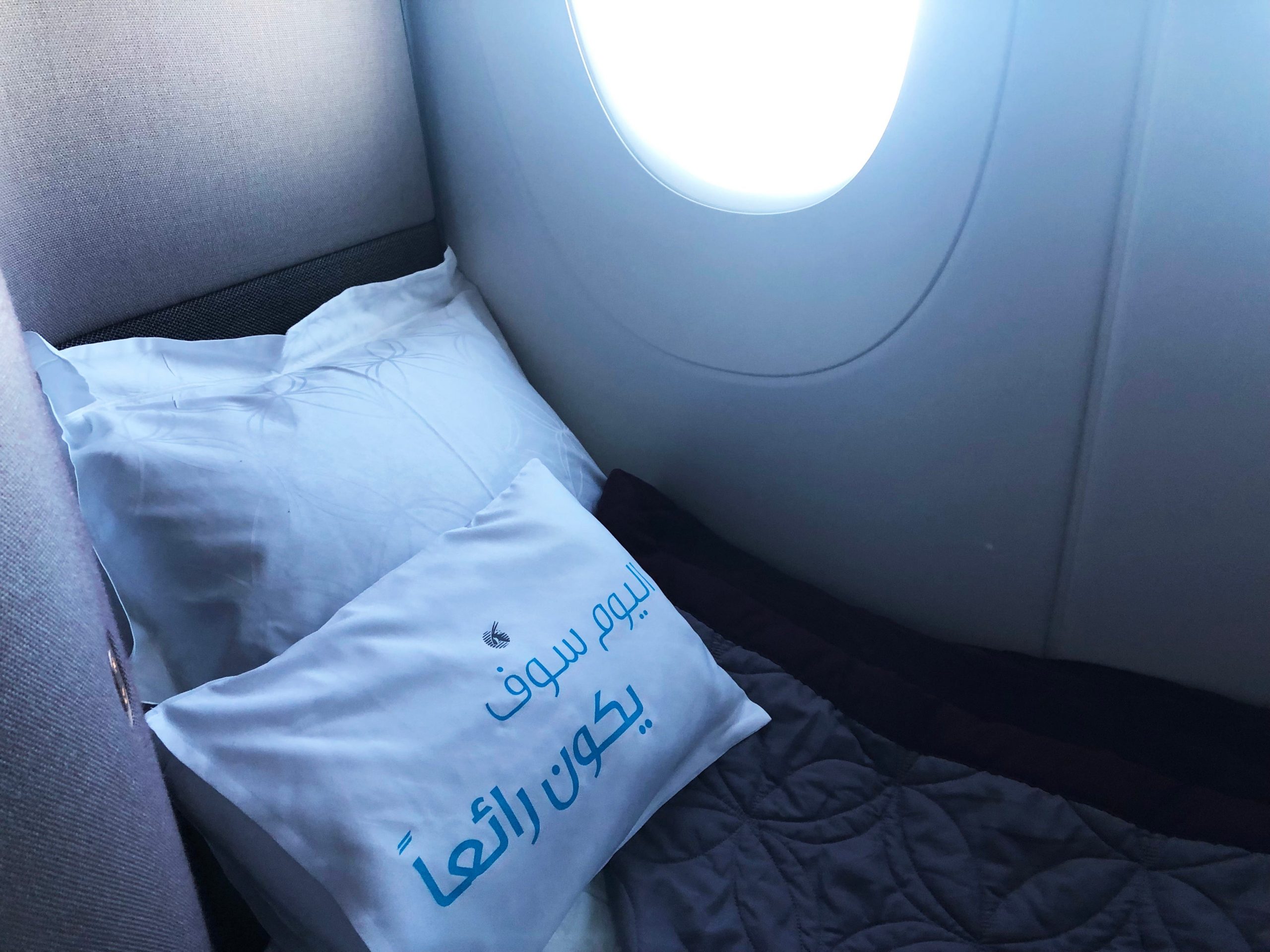 Bed on airplane next to window
