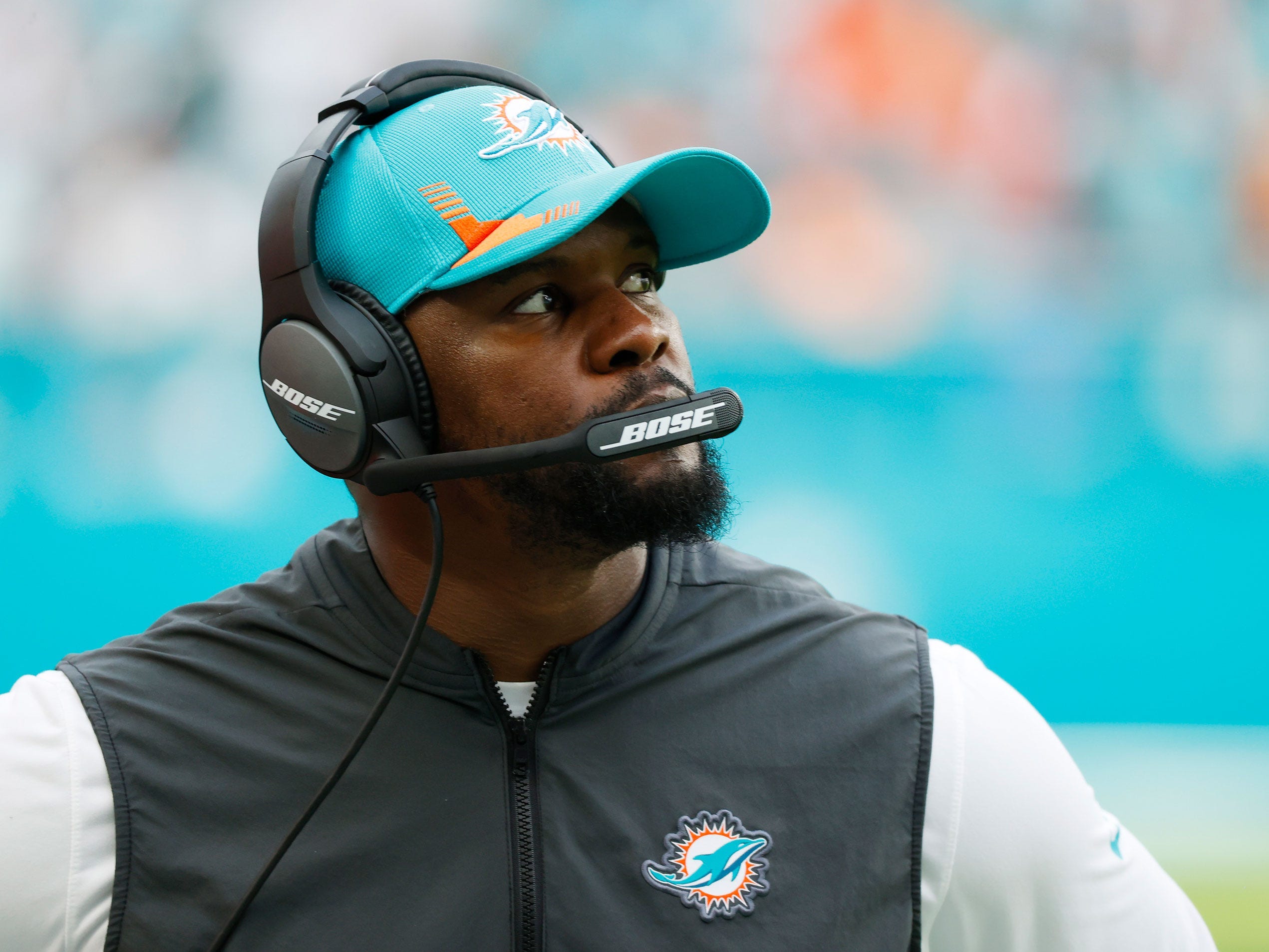 Brian Flores looks on while coaching a game against the New York Jets.