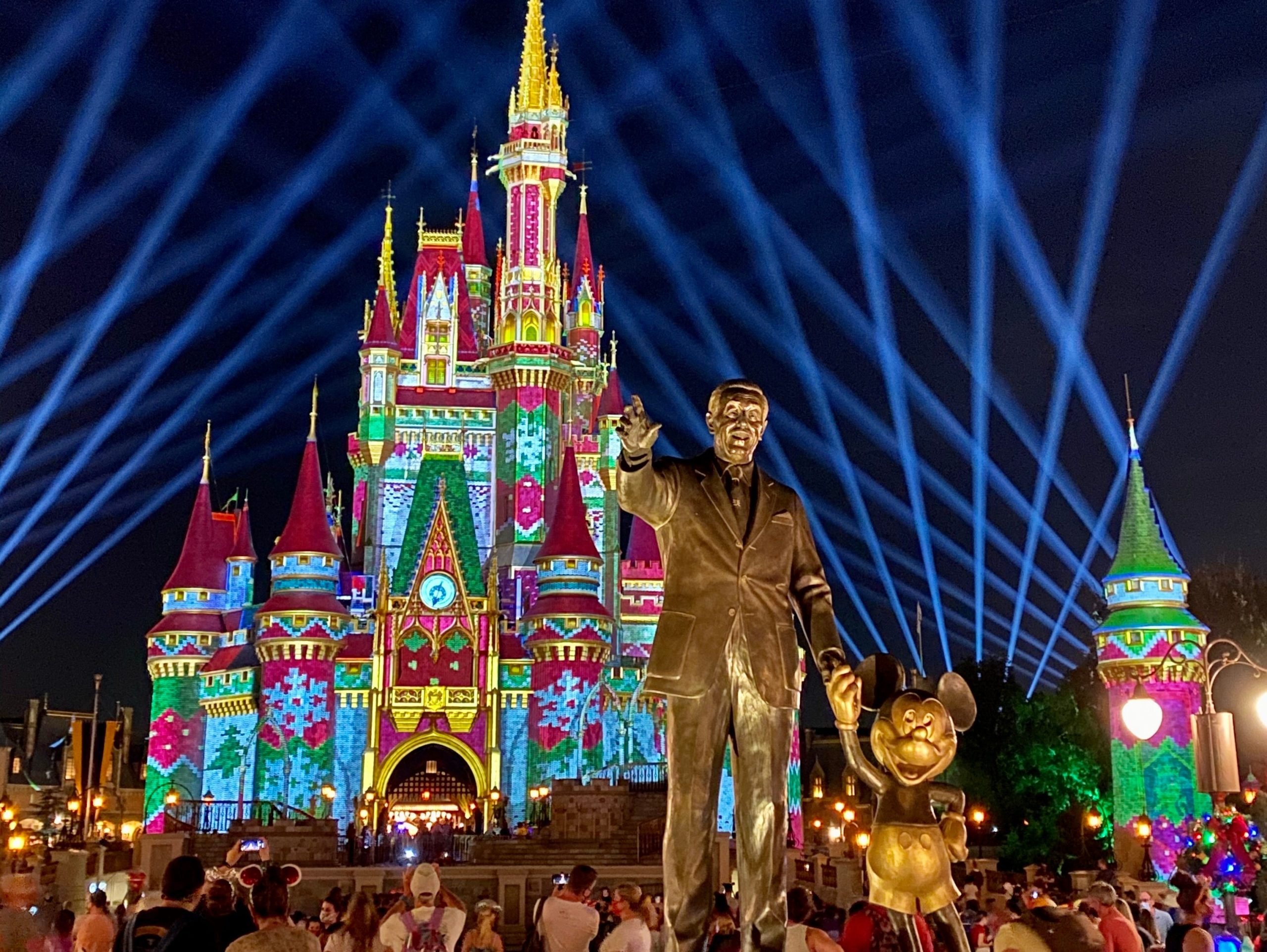 cinderella castle at disney world lit up for the nighttime show