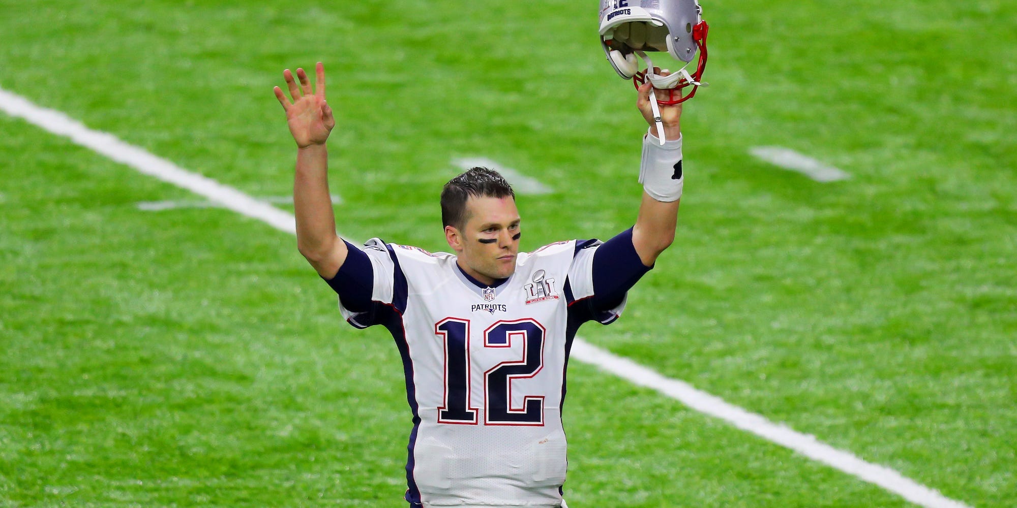 Tom Brady raises his hands and holds his helmet in the air after the Patriots beat the Falcons in the Super Bowl in 2017.