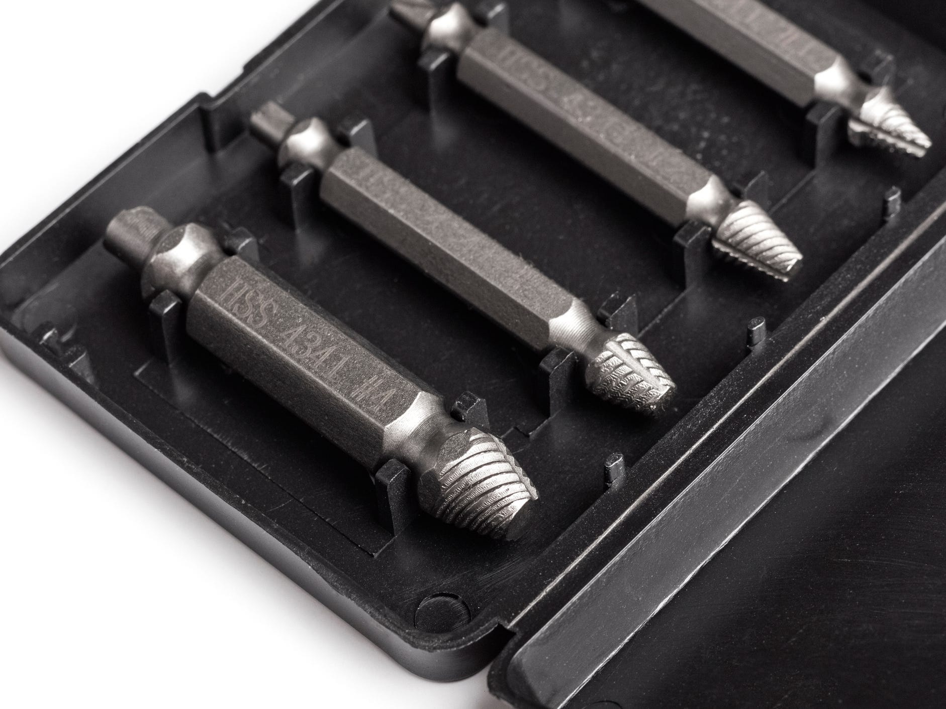 A set of screw extractors in a black box