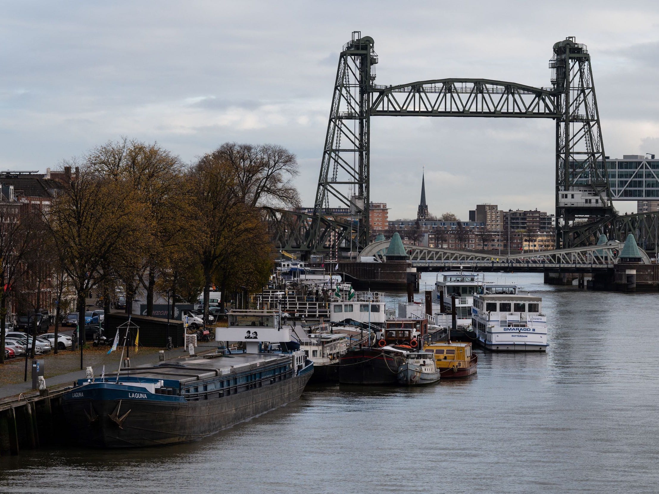 Barges docked on waterway near the Koningshaven "De Hef" lift bridge in Rotterdam, Netherlands