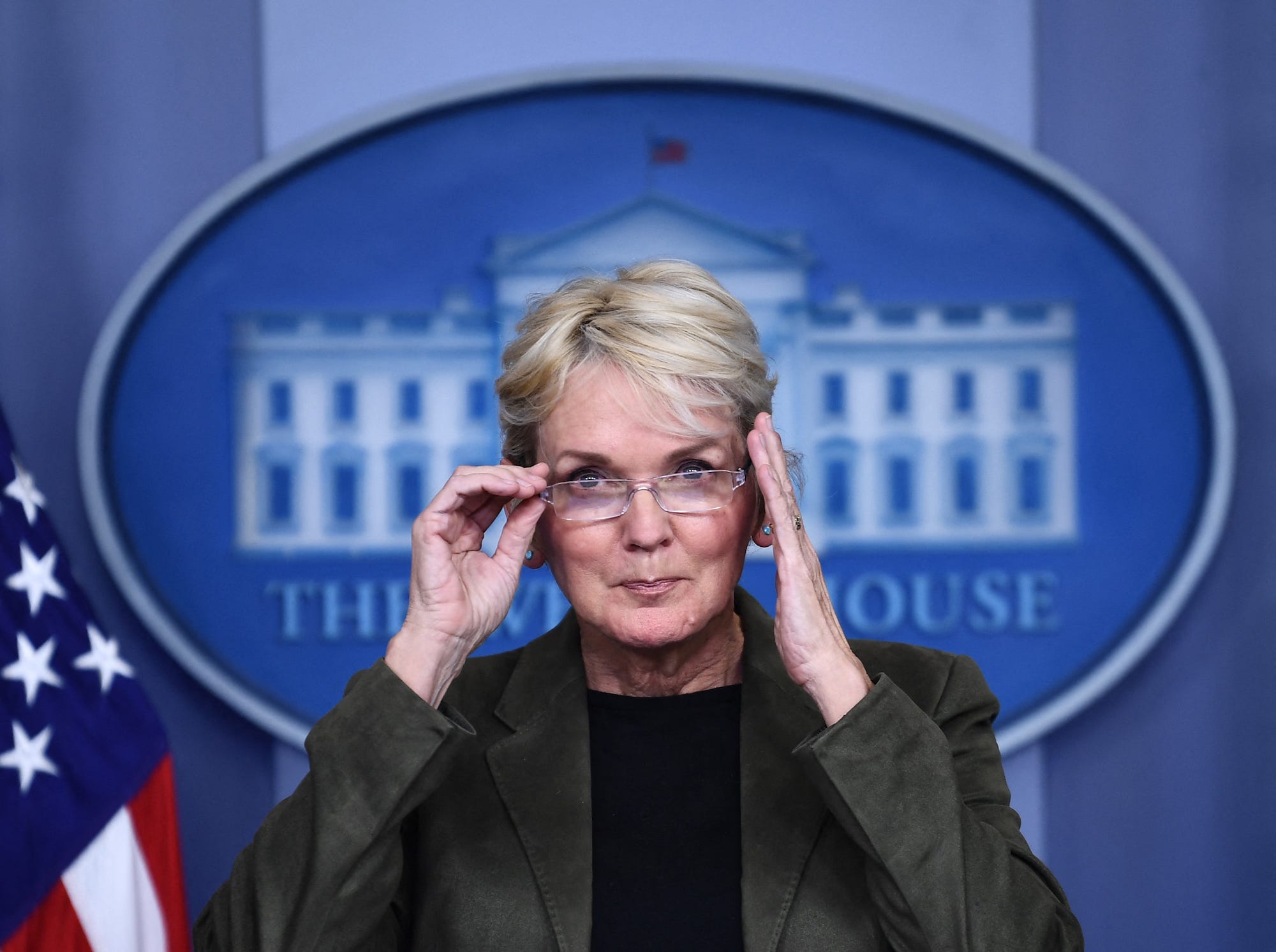 Energy Secretary Jennifer Granholm adjusts her glasses while speaking during a White House press briefing.