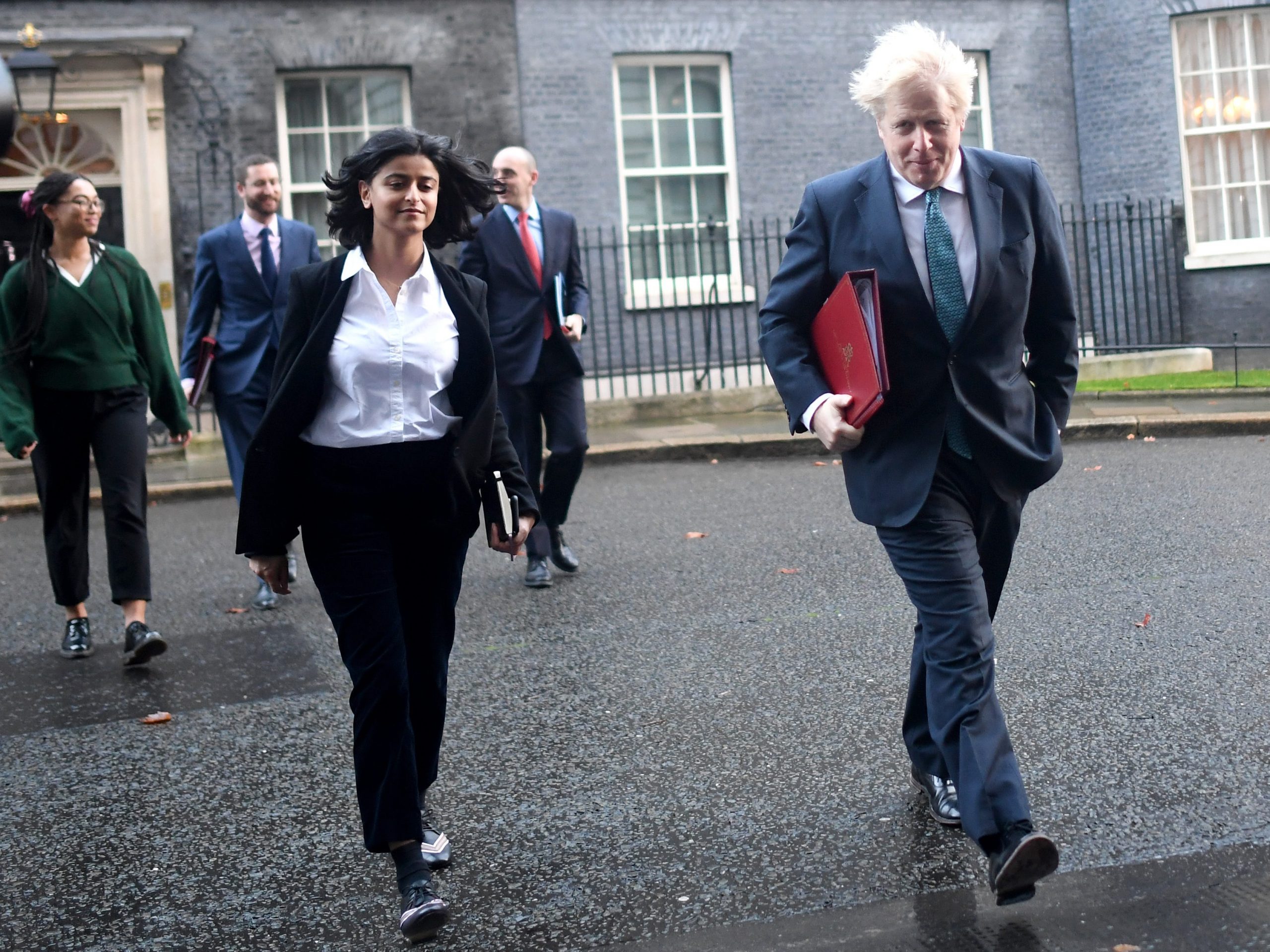 Prime Minister Boris Johnson leaves Downing Street for a Cabinet Meeting at the FCO with political advisor Munira Mirza (L), on December 15, 2020 in London, England.