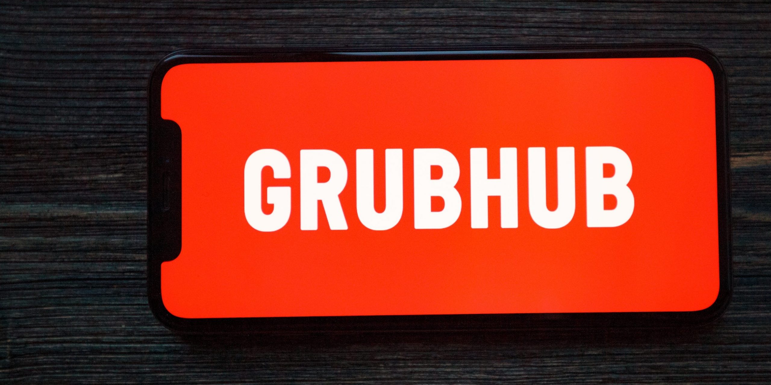 The Grubhub logo on an iPhone.