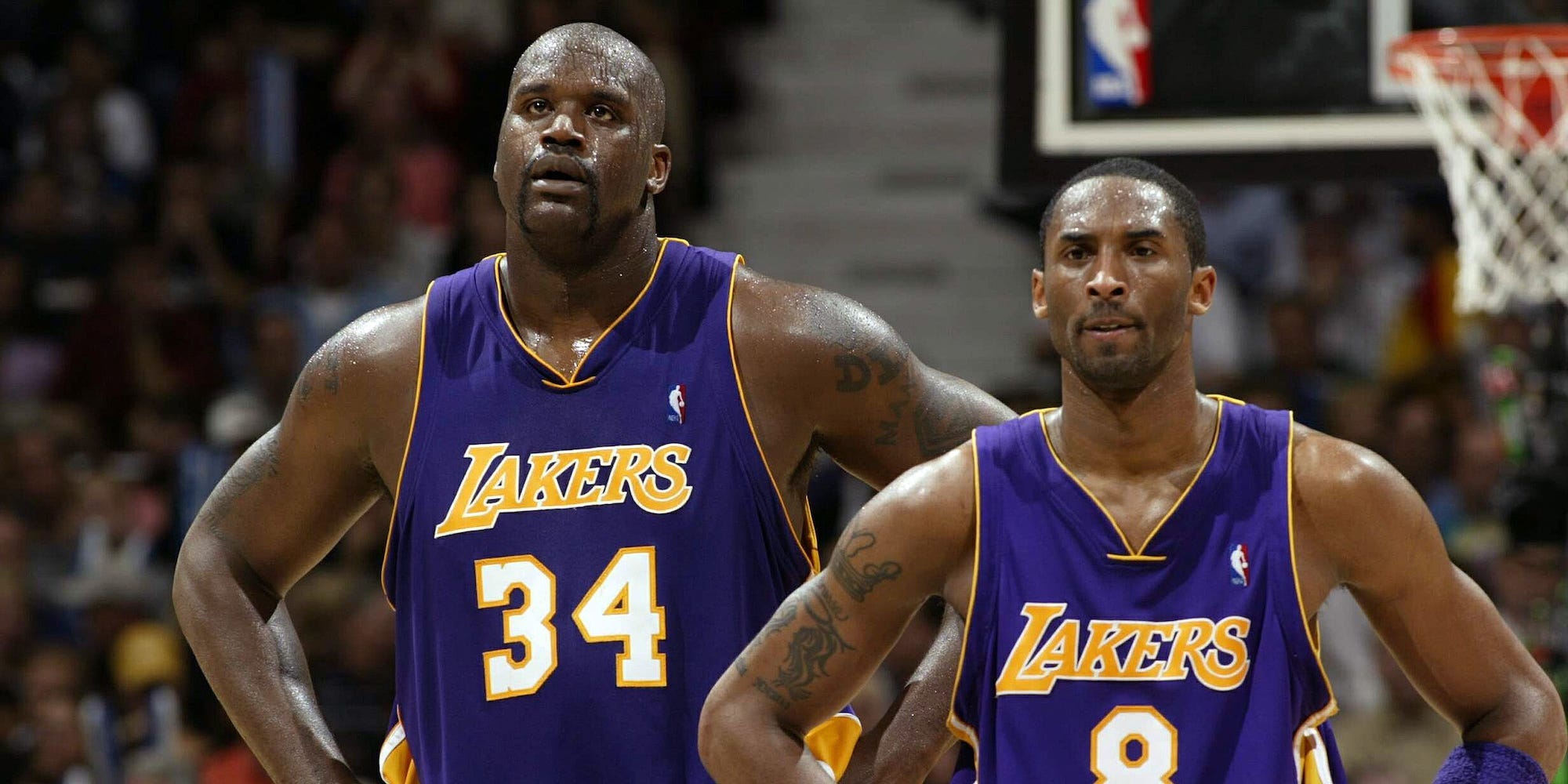Shaquille O'Neal and Kobe Bryant stand next to each other in a game in 2004.