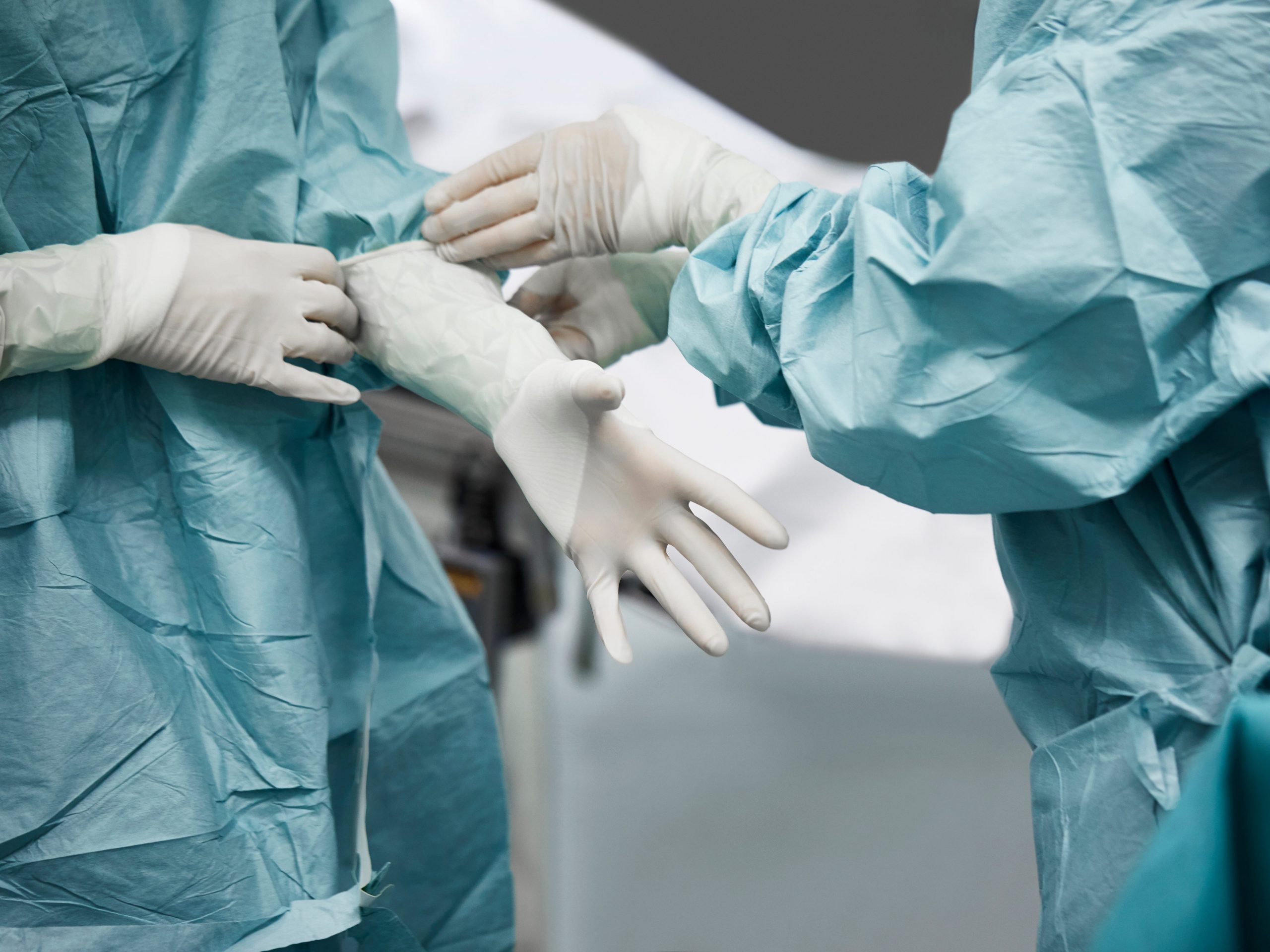 A stock image of two people donning personal protective equipment