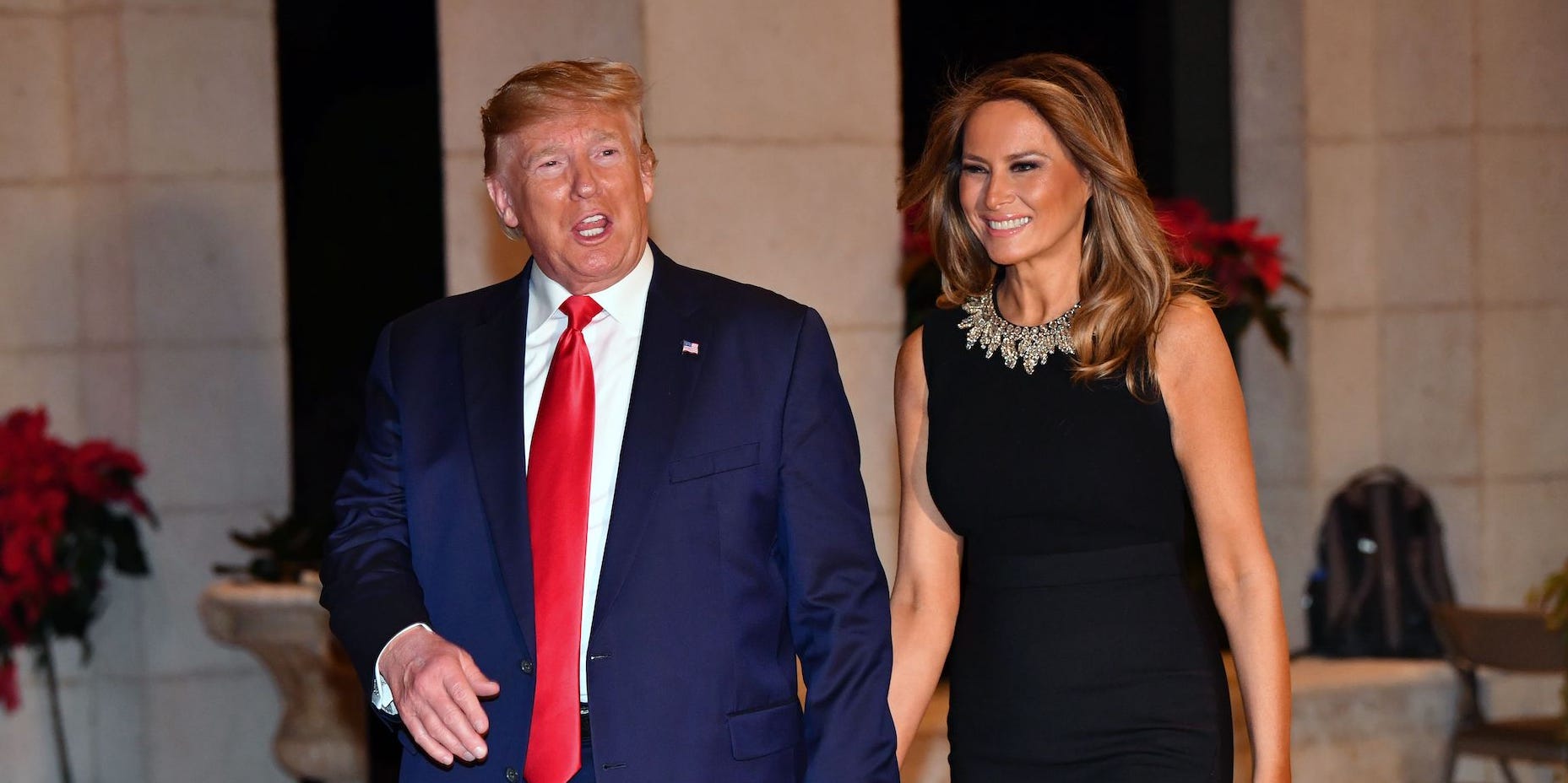 Donald and Melania Trump walking hand in hand outside Mar-A-Lago, Florida, in 2019