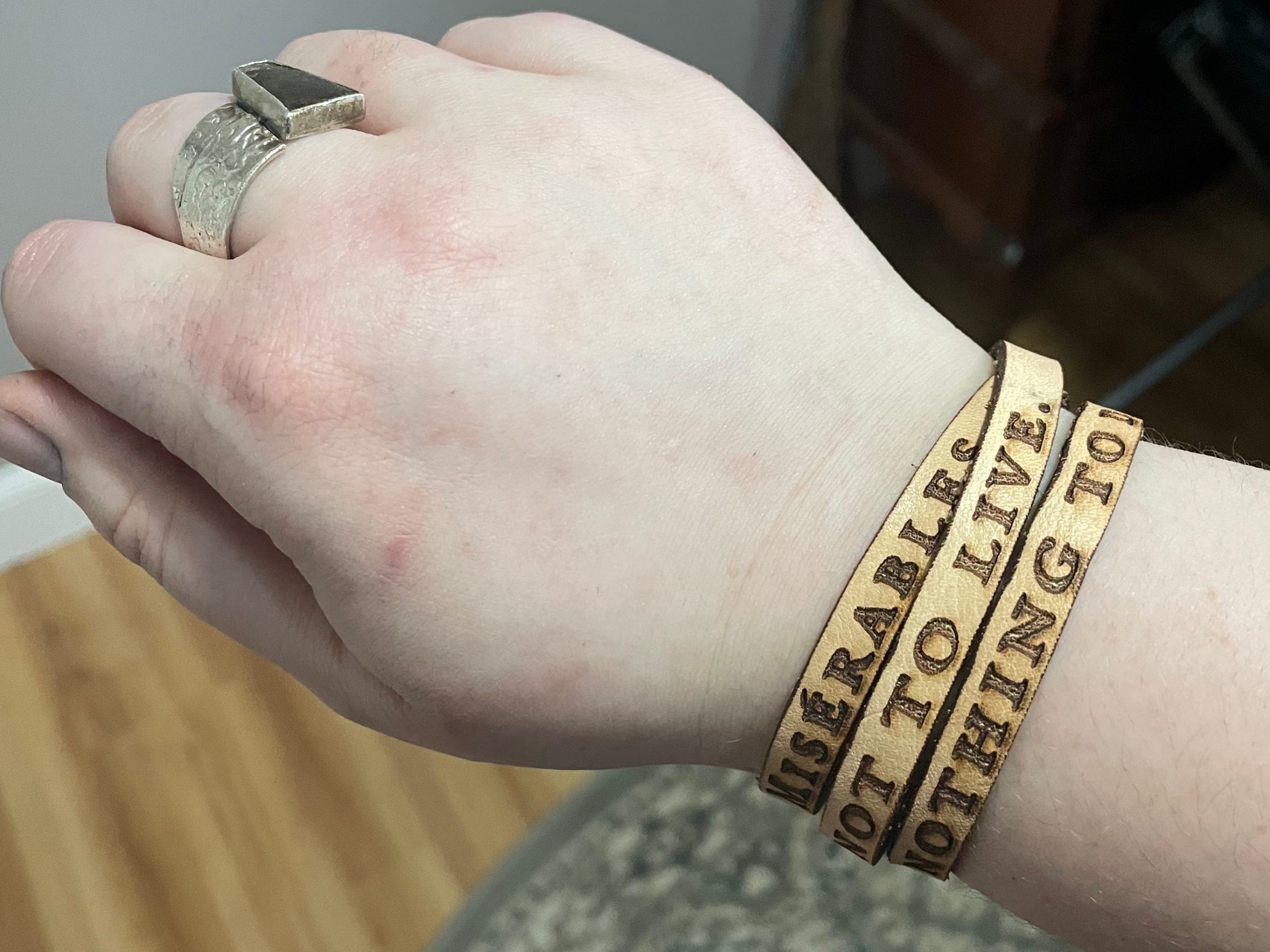 The writer wears bracelet with quote