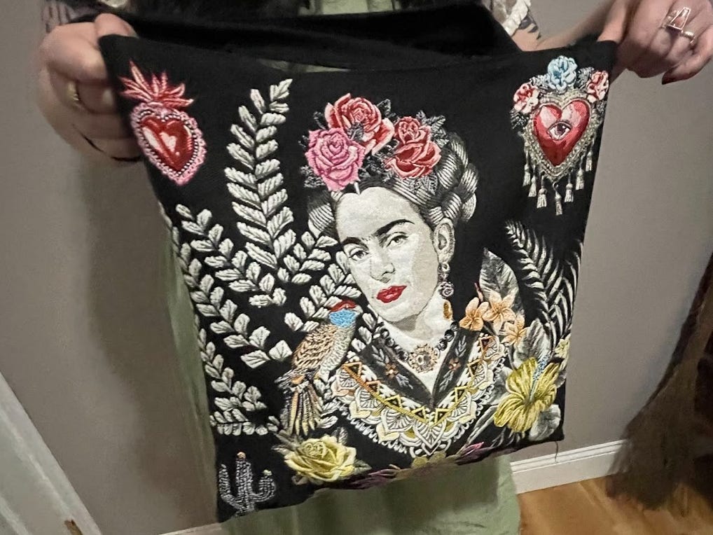 Writer holds up bag with Frida Kahlo on it