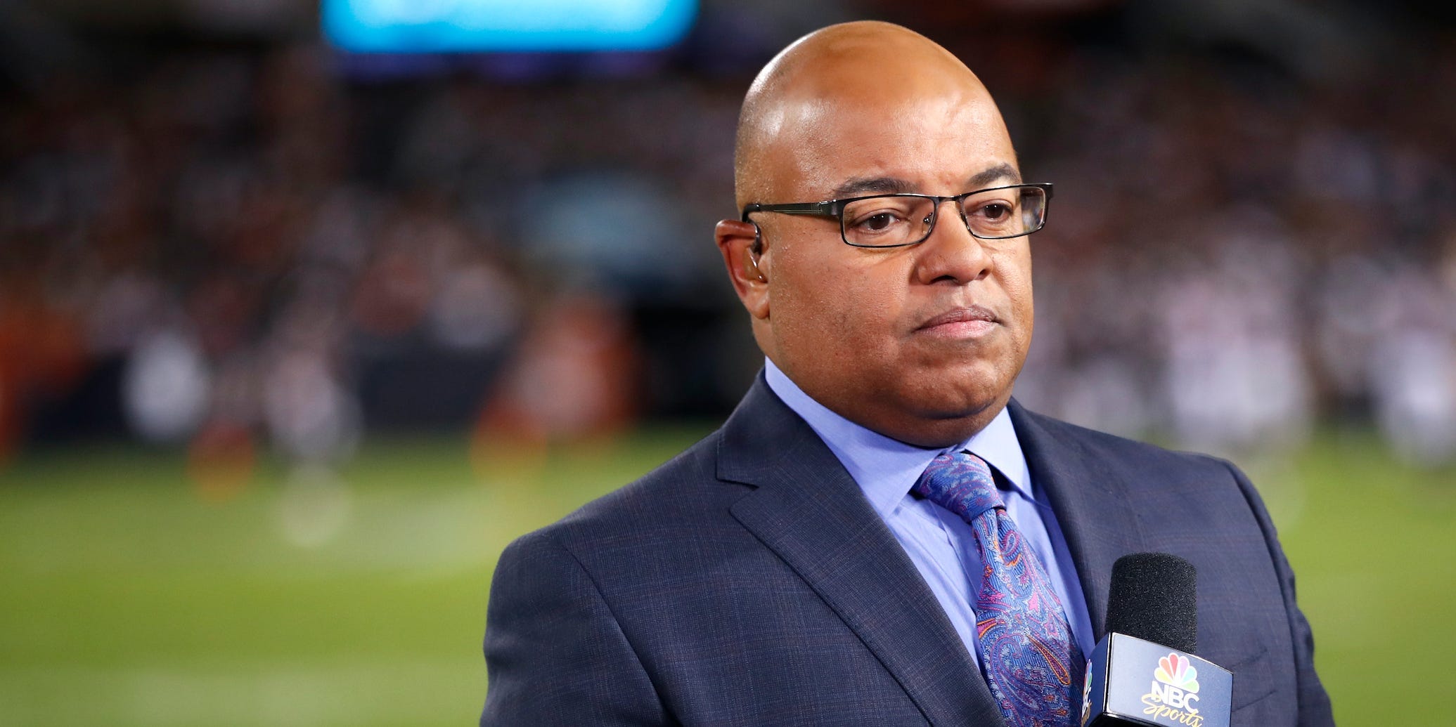 NBC sportscaster Mike Tirico works the sidelines during an NFL football game between the Green Bay Packers and the Chicago Bears, Thursday, Sept. 5, 2019, in Chicago.