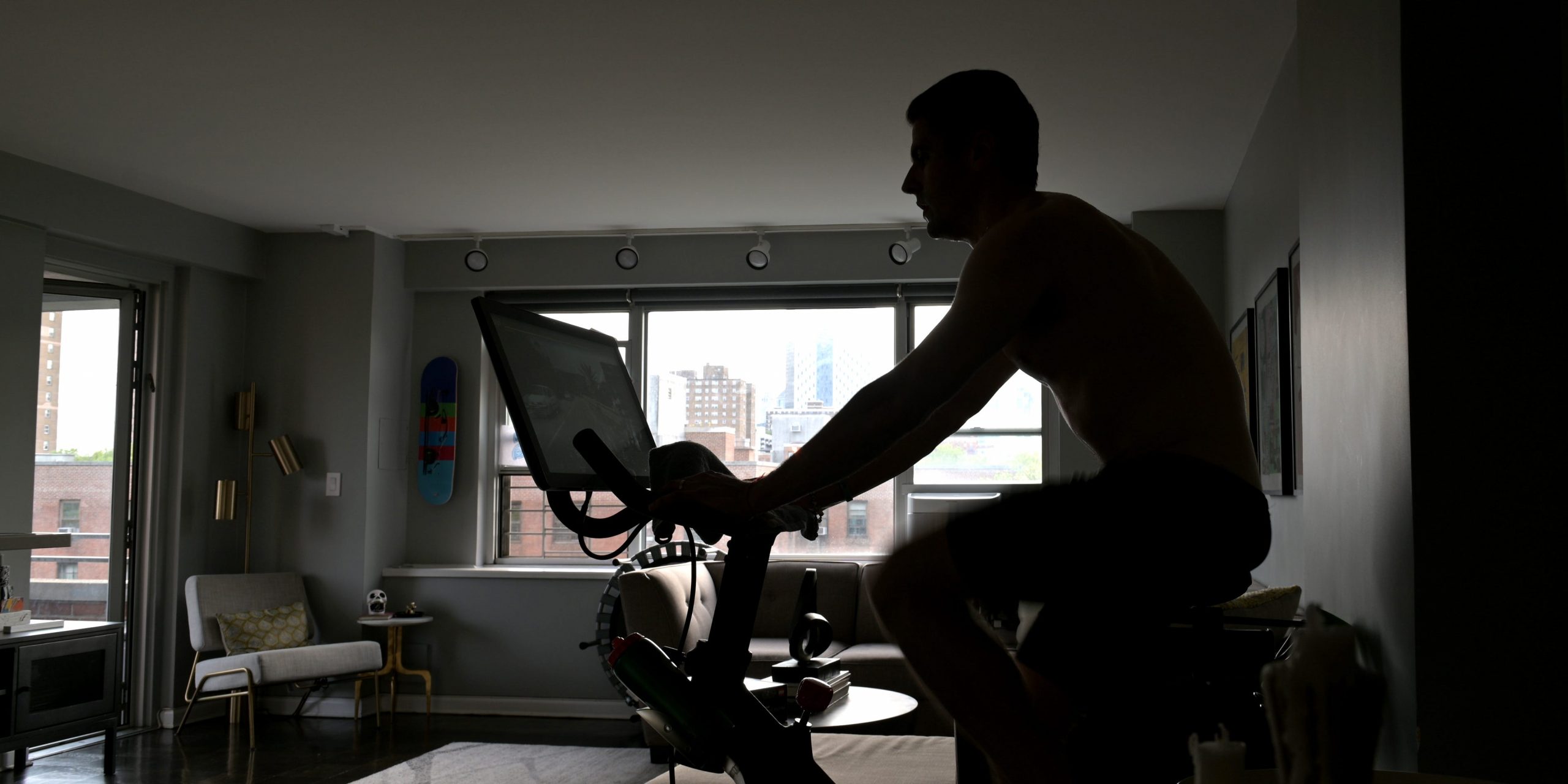 A man riding a stationary bike in his living room.